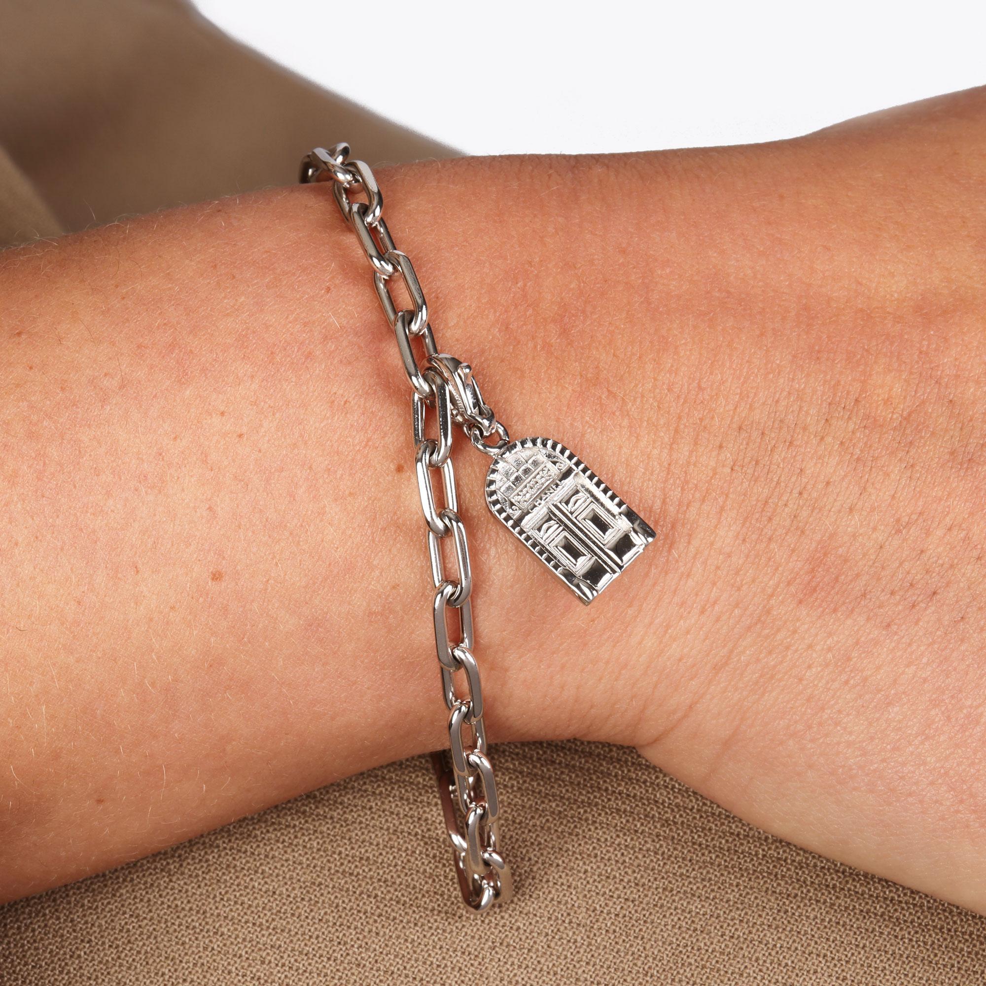 This charm by Chanel features a door design with the number 18 in 18ct White Gold. It can be worn as a charm on a bracelet or as a pendant on a necklace. Accompanied by a Chanel Certificate. 
ITEM