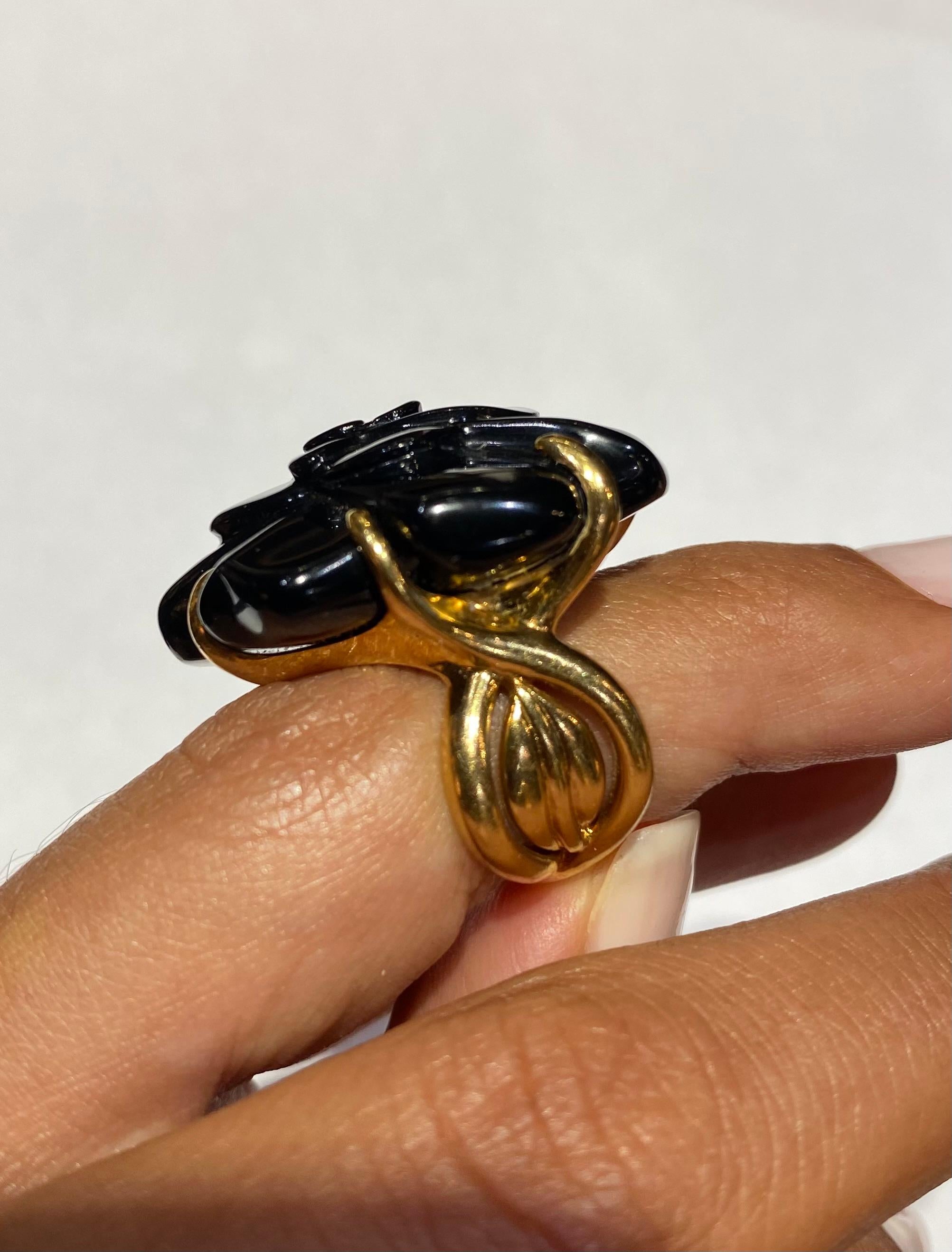 Stunning 18k Gold Chanel Ring. It has a Black Onyx carved 'Camelia' Flower, Coco Chanel's favorite flower and an iconic emblem of the brand. The ring is pre-owned and in Excellent Condition. 