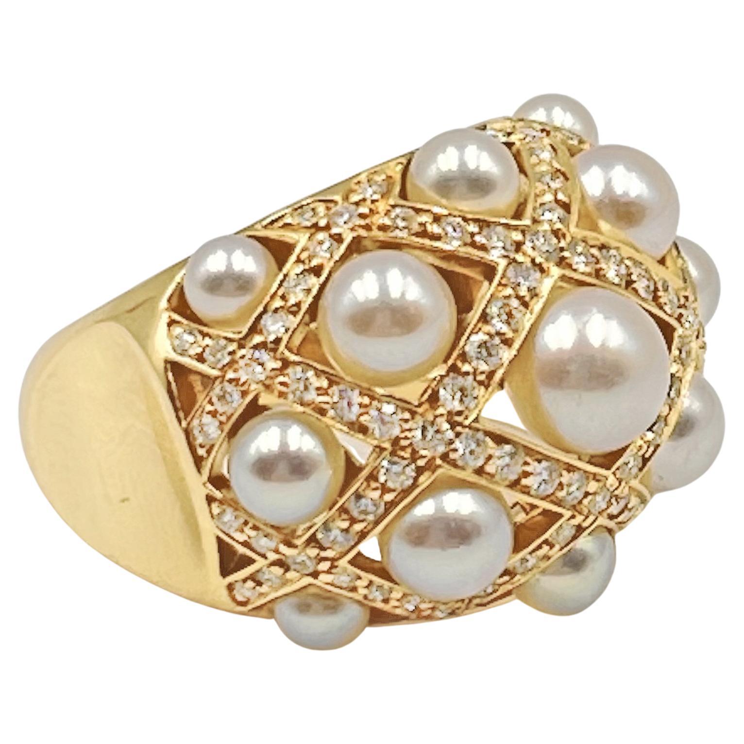 18k yellow gold 'Matelassé' pearl and diamond ring by Chanel.  15.7mm dome design top accented by thirteen cultured pearls (3-6mm) and 108 round full-cut diamonds weighing approximately 1.60 total carats (E-F color, VVS1-VVS2 clarity). 
Tapered 5mm