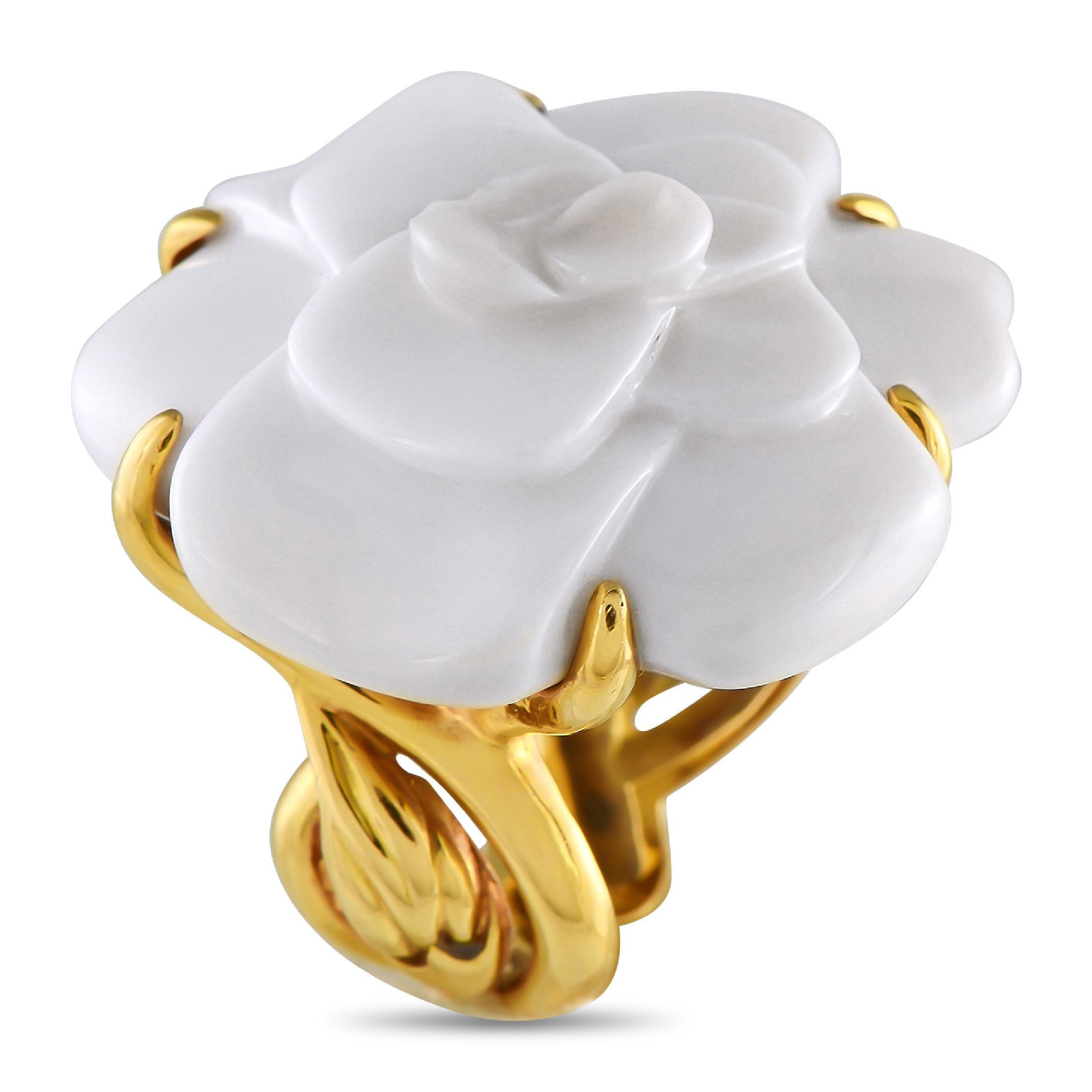 Chanel's large model Camlia ring radiates beauty with its bold presence and sculpted simplicity. The thick, stylized band is fashioned from 18K yellow gold. The shank features a leaf-like motif, with oversized prongs that support a camelia flower