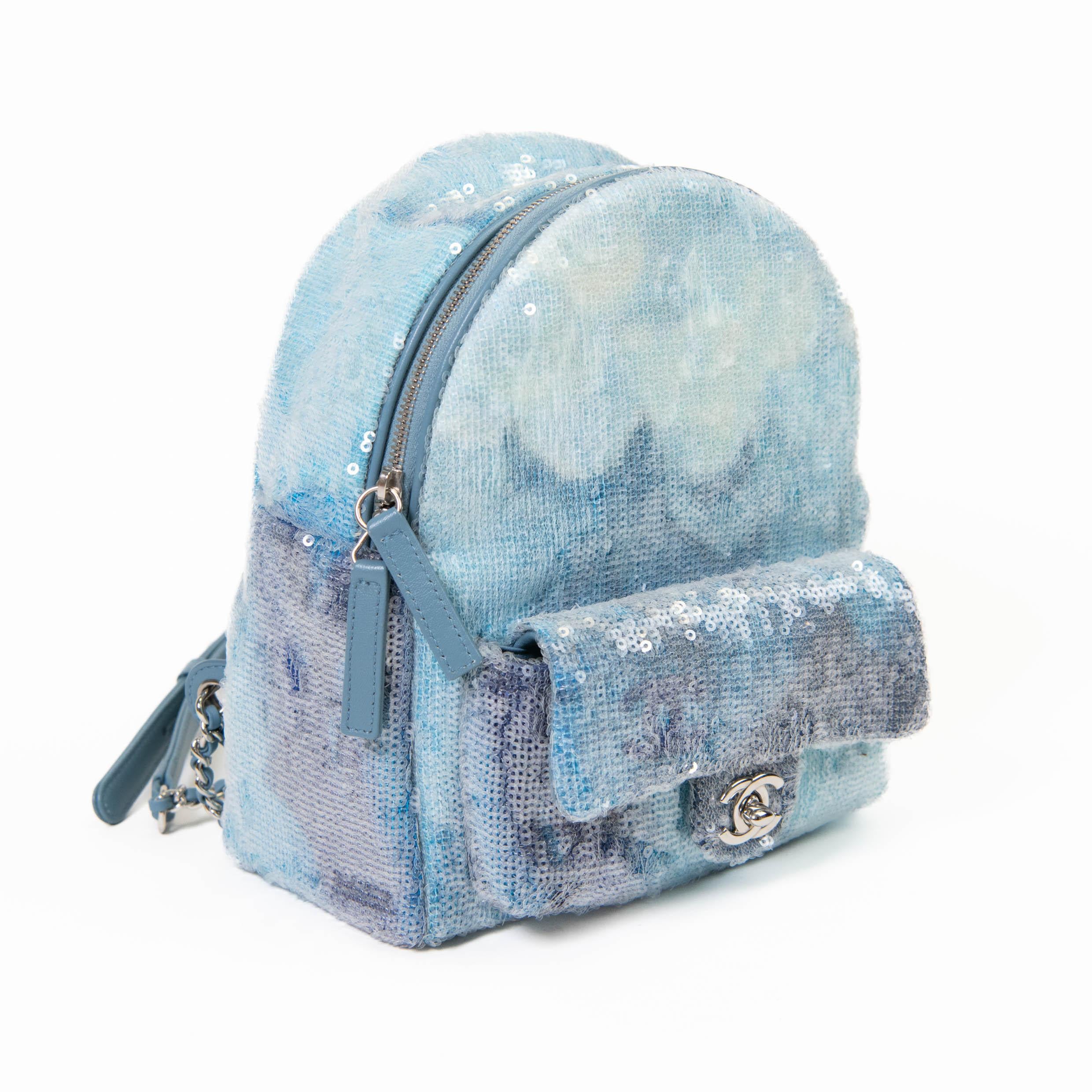 100% Authentic 

 Shiny multi blue shade sequin with silver-tone hardware
- CC logo detail
- Zipper opening with front flap pocket
- Adjustable shoulder straps
- Made in Italy

19 x 21 x 10 cm

Very Good Condition- Some marks to the exterior as
