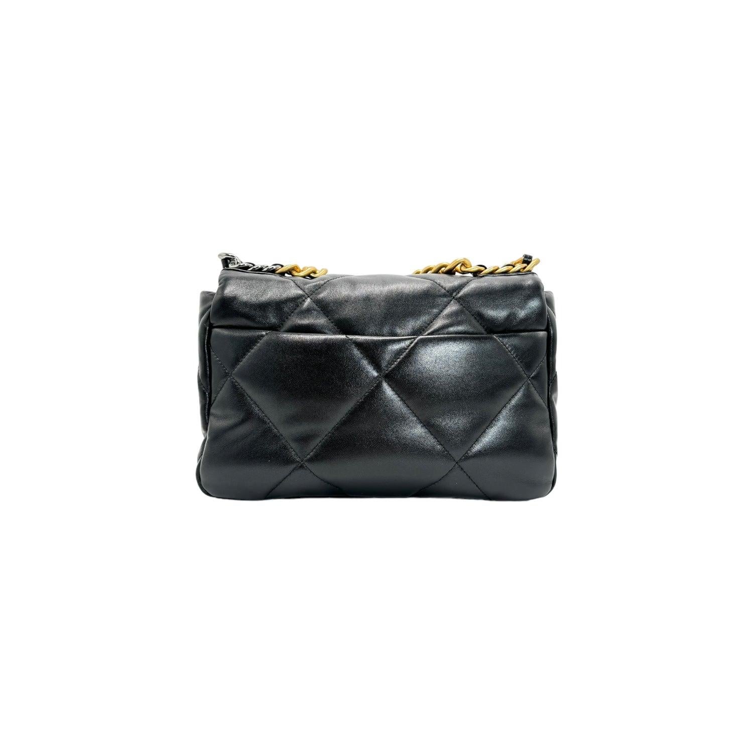 Expertly crafted by Chanel, this black quilted lambskin bag features aged gold and silver tone hardware, threaded leather straps for a unique touch, and a spacious interior with a single flat pocket for organization. The CC turn-lock closure and