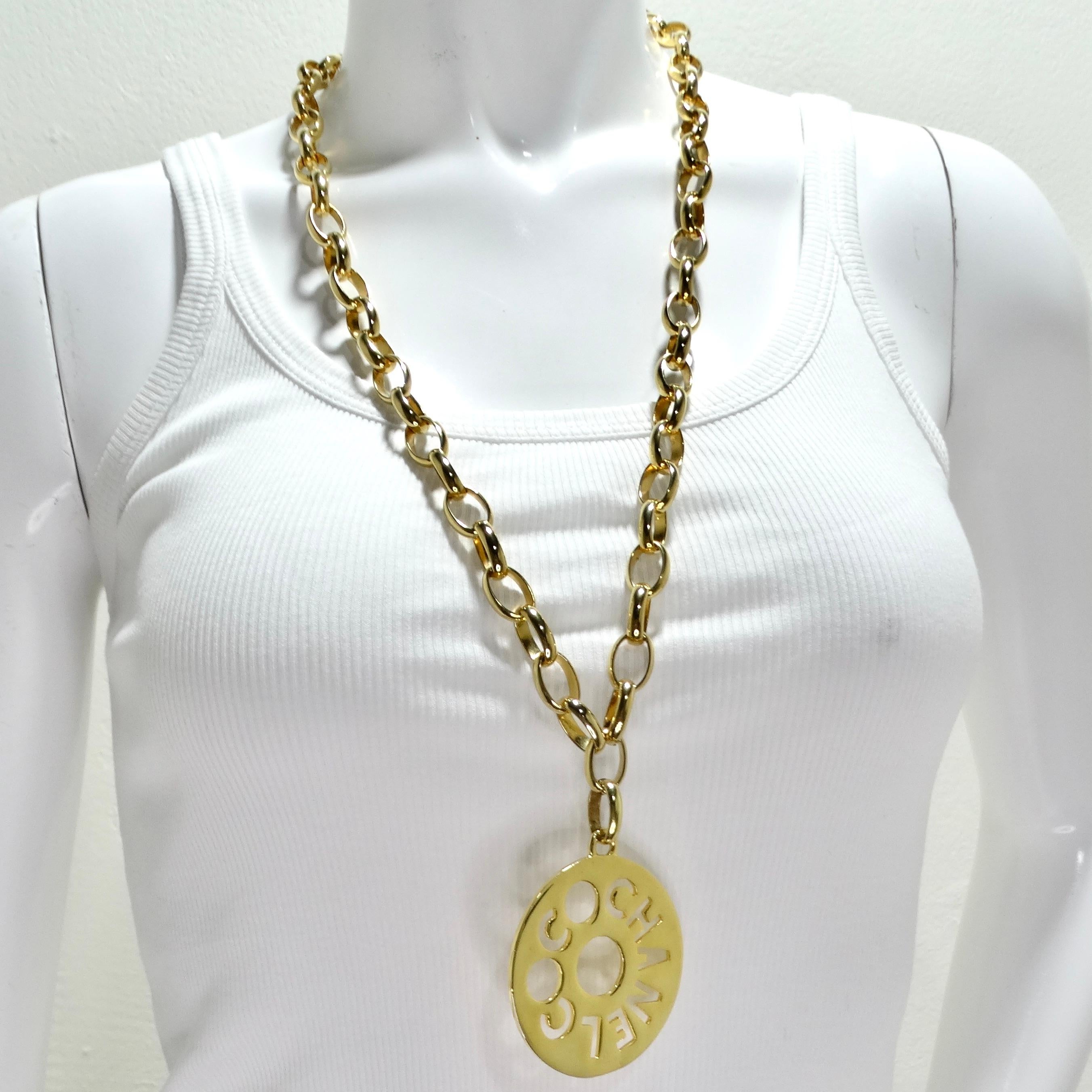 Make a statement with the Chanel 1970s Gold Tone Oversize Pendant Necklace, a true embodiment of luxury and elegance. This stunning piece features a chunky gold-tone chain link necklace adorned with a large round pendant showcasing the iconic Coco