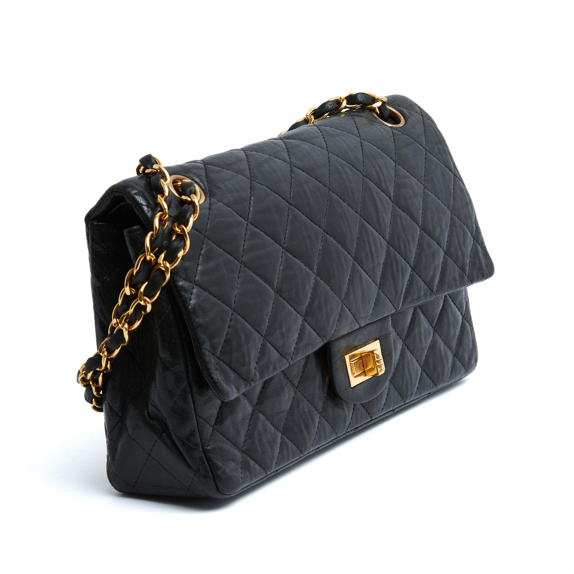 Chanel bag circa 1970 model 2.55 Classic or 25 size in quilted black aged leather, metal parts and shoulder strap in gold metal, burgundy leather interior with one compartment and a large inside pocket, double flap, pocket on the back, ... chain