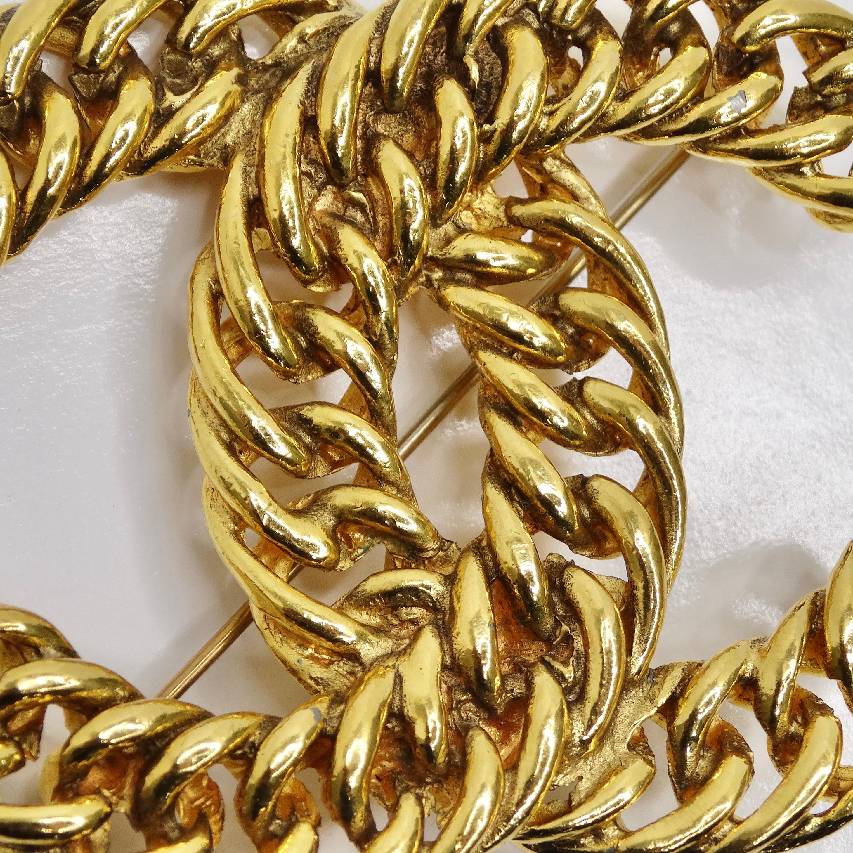Introducing the Chanel 1980s 24K Gold Plated CC Chain Brooch, a timeless and elegant accessory that adds a touch of vintage Chanel sophistication to any ensemble. Crafted from luxurious 24K gold plated metal, this brooch features the iconic Chanel