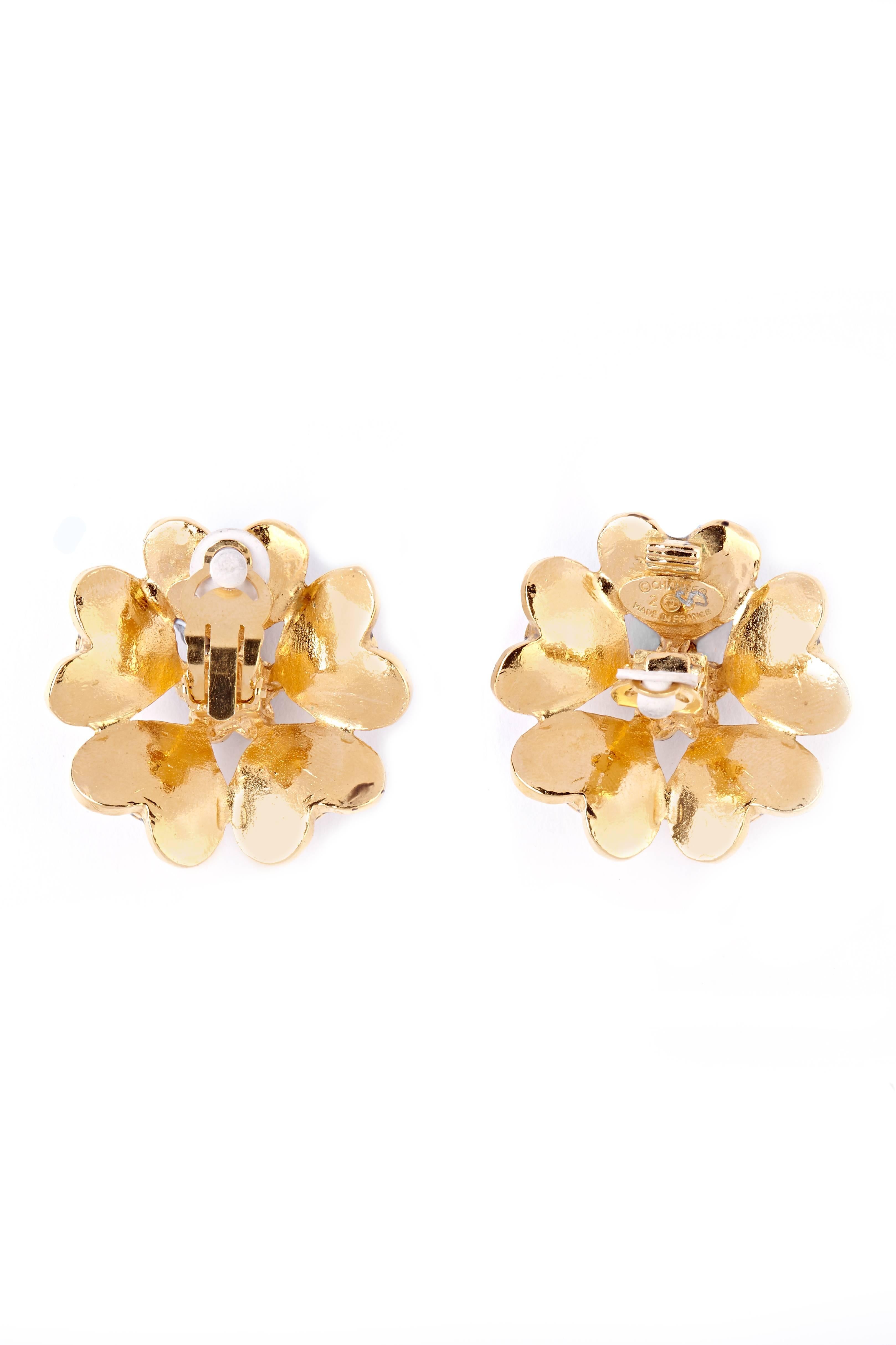These wonderful statement Chanel 1980s earrings are a rare find and were issued before the design house had had their jewellery line officially trademarked. The design comprises of five gold metallic heart shaped petals arranged around a faux pearl