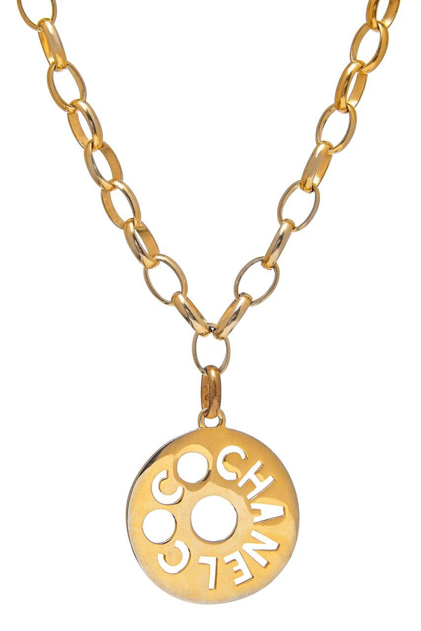 Striking vintage Chanel large medallion necklace. This fabulous piece by Chanel and made in France dates from the early 1980's and is inscribed on a link.  Made in gilt metal, it features a long and chunky chain with a flat disk medallion pendant