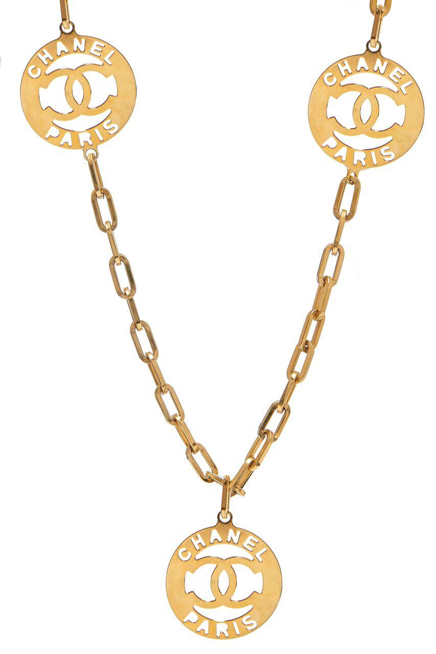 This wonderful Chanel late 1980s gold tone link necklace with cut-out medallion charms is a rare piece and extremely wearable. The chain measures 39” and features three large round hanging charms just over 1.5