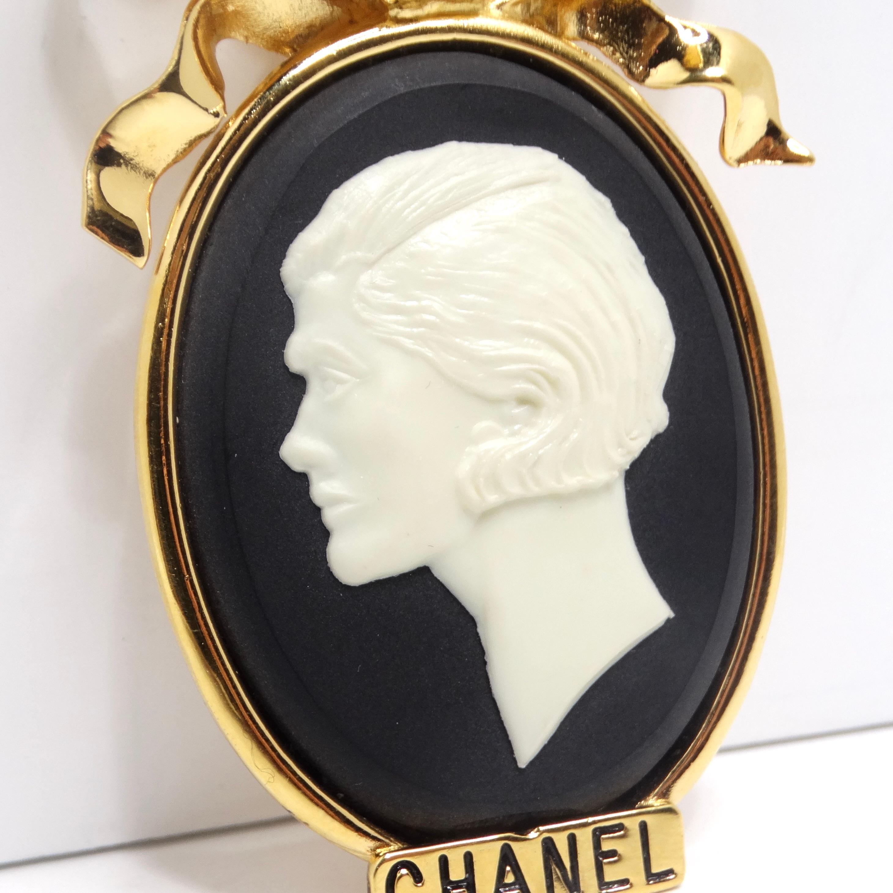 Indulge in the allure of vintage Chanel with the exquisite Chanel 1980s Gold Tone Cameo Brooch. This remarkable brooch is a captivating homage to the iconic Coco Chanel, featuring a black and white large cameo that captures the essence of the