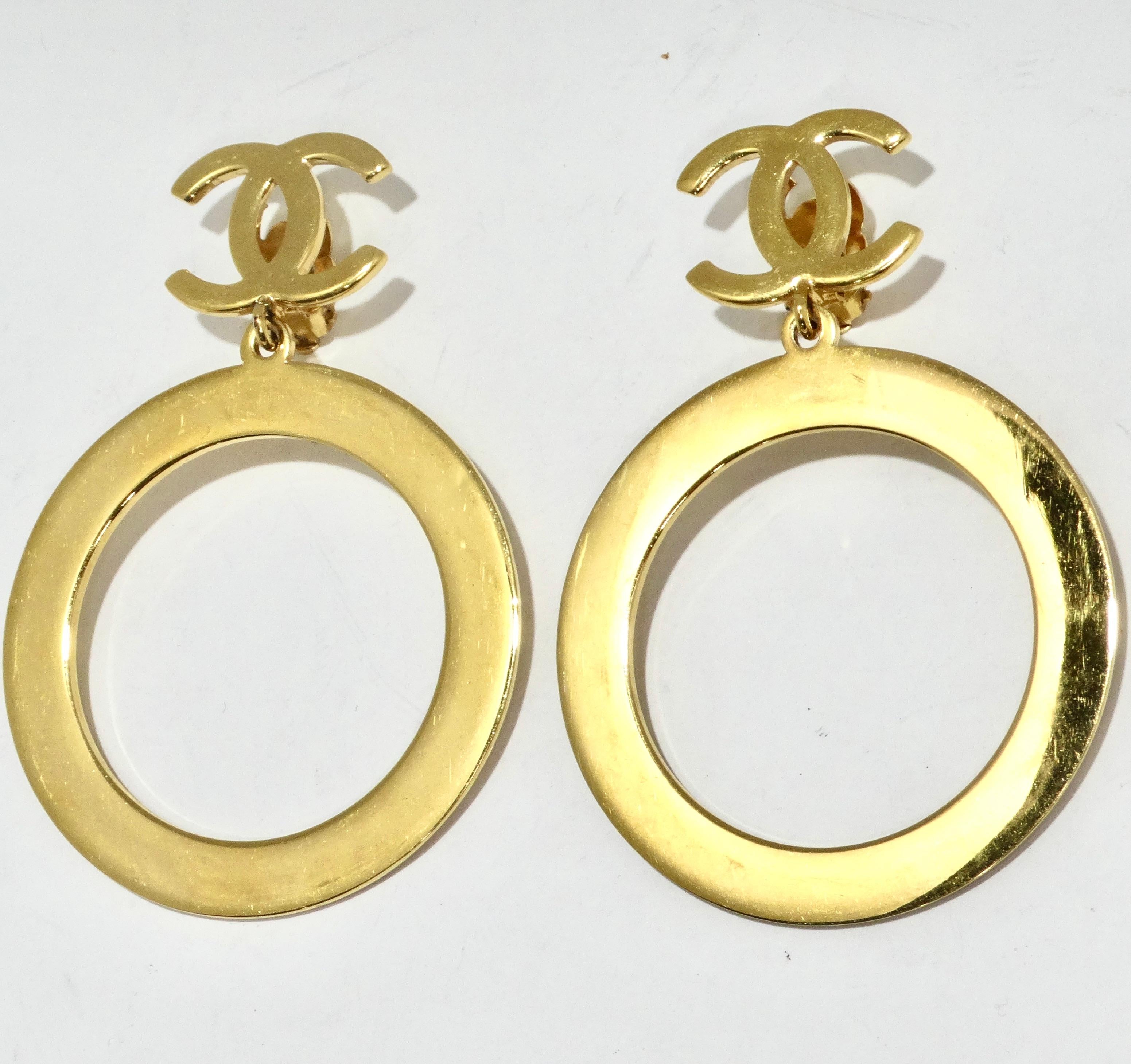 Make a bold statement with the Chanel 1980s Gold Tone Logo Jumbo Hoop Earrings – yellow gold plated earrings that epitomize iconic luxury. These statement earrings feature signature Chanel interlocking 'C' logos that gracefully give way to jumbo