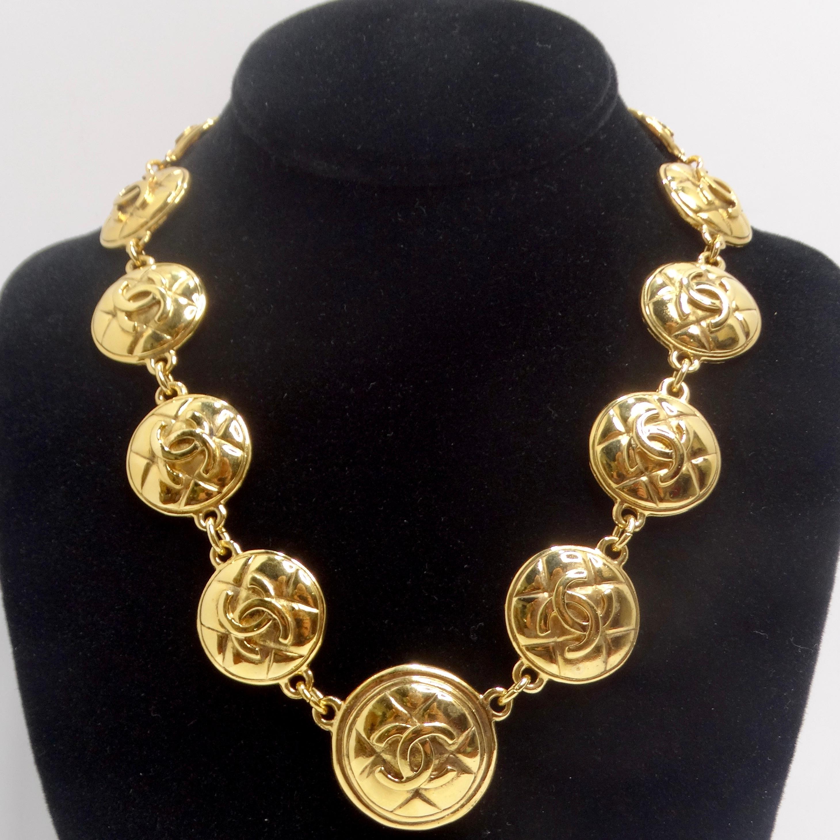 Introducing the Chanel 1980s Gold Tone Logo Quilted Medallion Necklace – a classic yellow gold plated link necklace that embodies vintage glamour. This timeless yet glamorous necklace features an arrangement of gold plated round charms, each