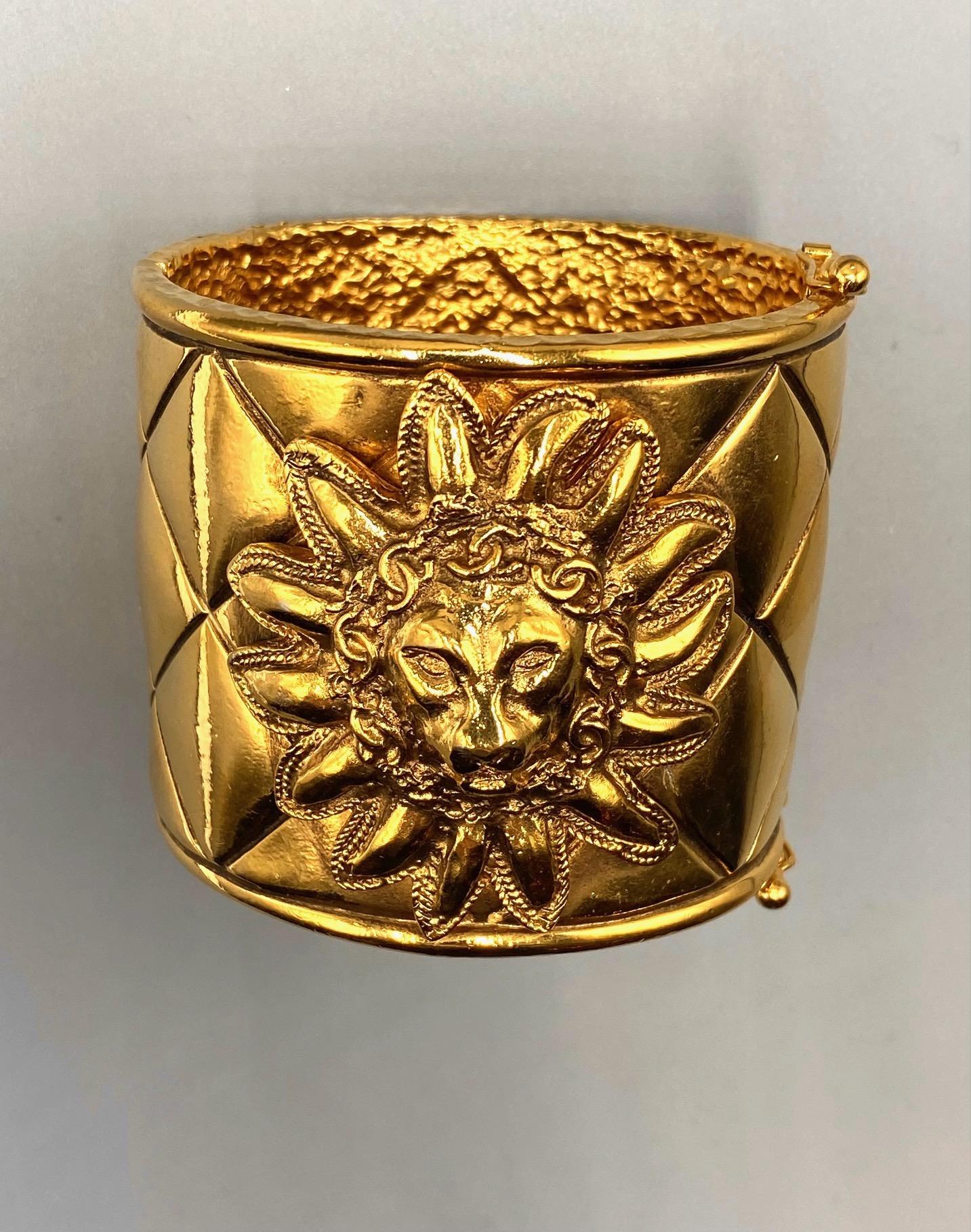 Presented is one of Chanel's iconic gold quilt design cuff bracelets with lion face by famous French designer Robert Goosens of Paris. Goosens first met Coco Chanel in 1953 and continued with a life long career of designing bijoux for her. One of