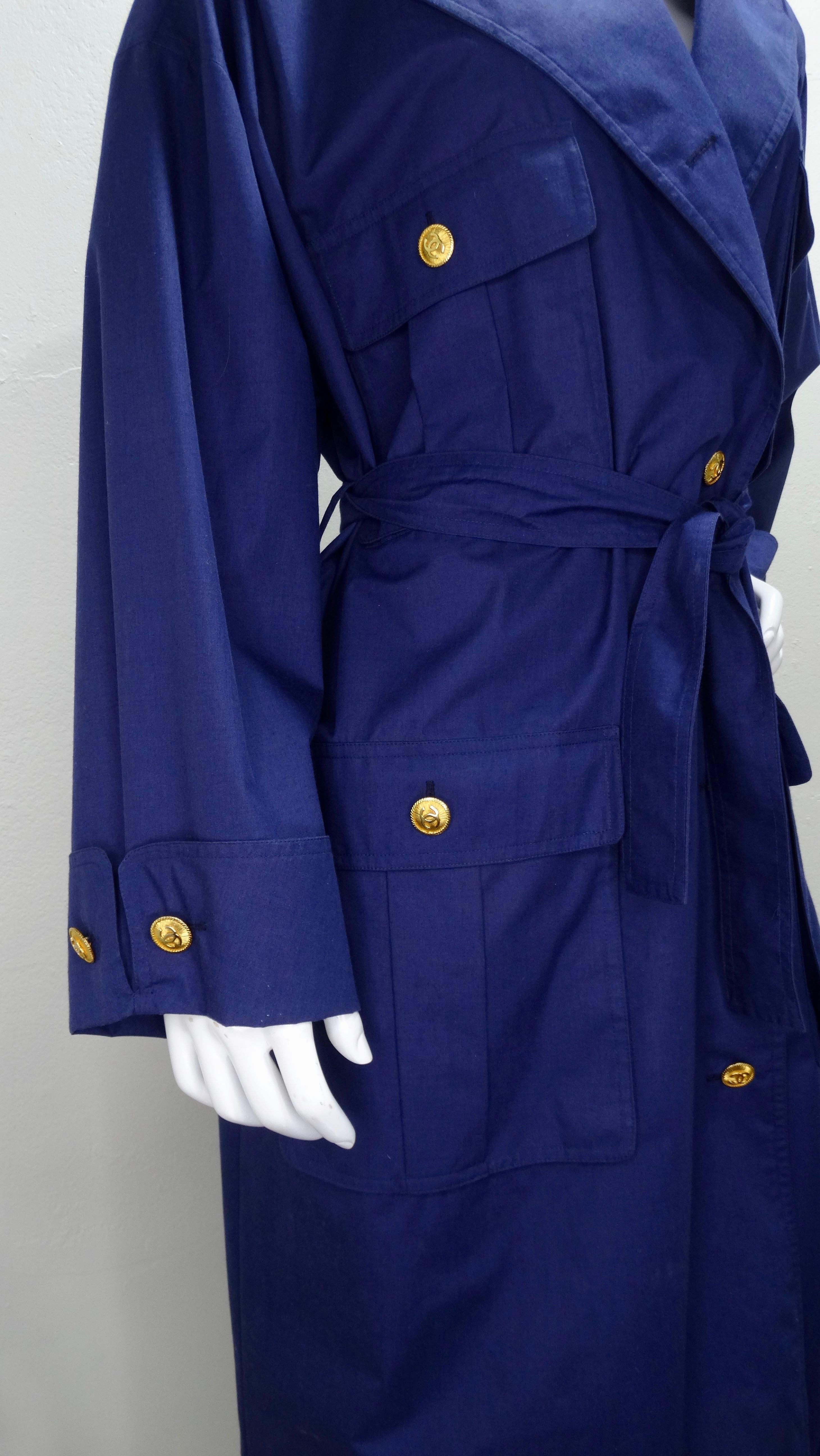 Let Chanel keep you Chic! Circa 1980s, this trench coat is a great navy blue color and features a notched collar, 4 large front pockets, cuffed long sleeves and a fabric tie belt. Accented throughout are gold plated CC buttons with a rope trim.