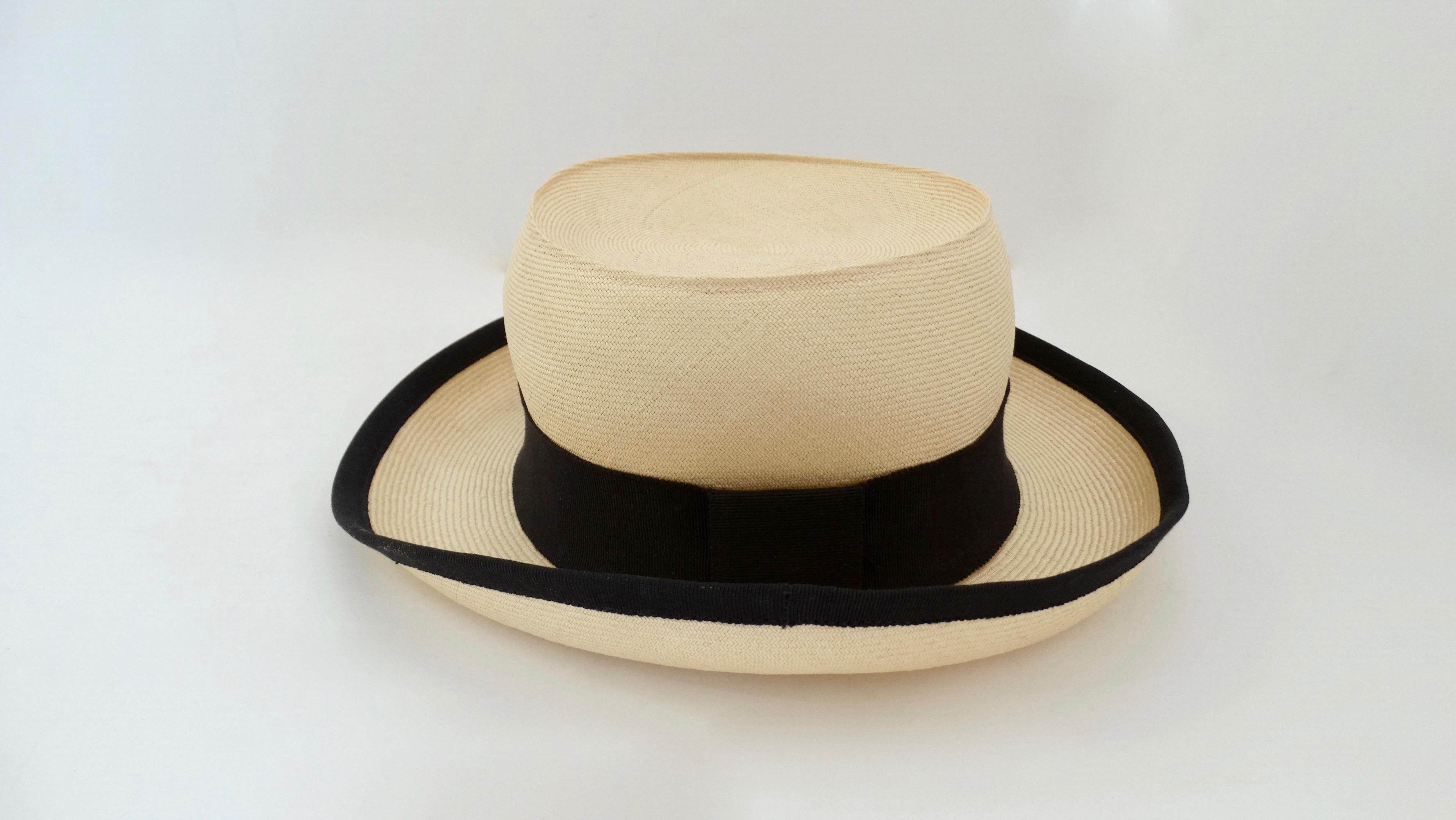 Treat yourself with a piece of Chanel! Circa 1980s, this boater hat is made of neutral colored straw and features a black grosgrain ribbon around the base of the crown and outer trim of the brim. From brunch to vacations, to lounging by the pool,