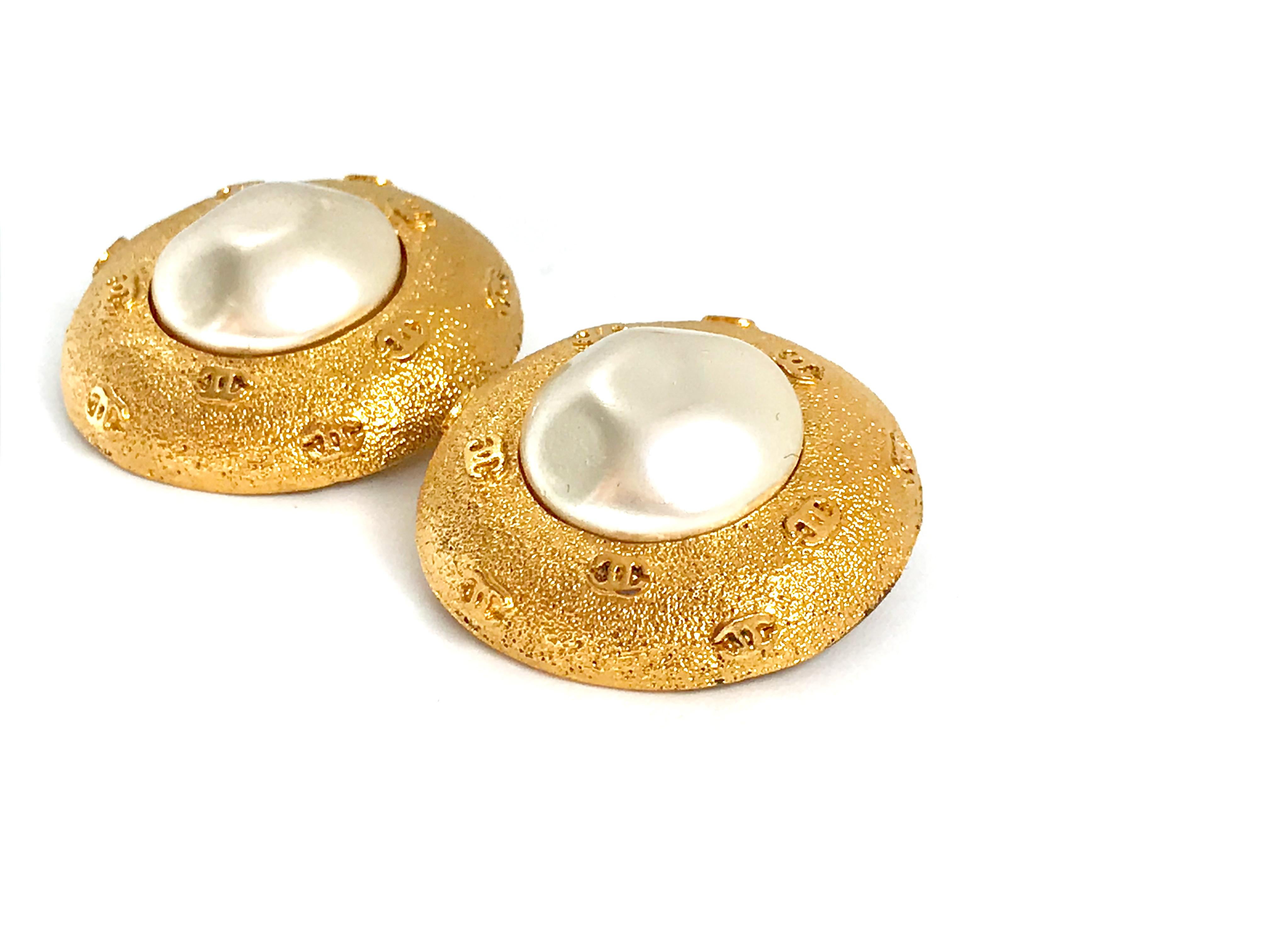 Fabulous Chanel 1980s Vintage Clip On Faux Pearl Earrings.  Feature multiple CC logos around the pearl centre.  From the Chanel heyday under the creative guidance of Victoire de Castellane.

Size: 3 cm / 1.3'' (approx.)  

Hallmarked & numbered with