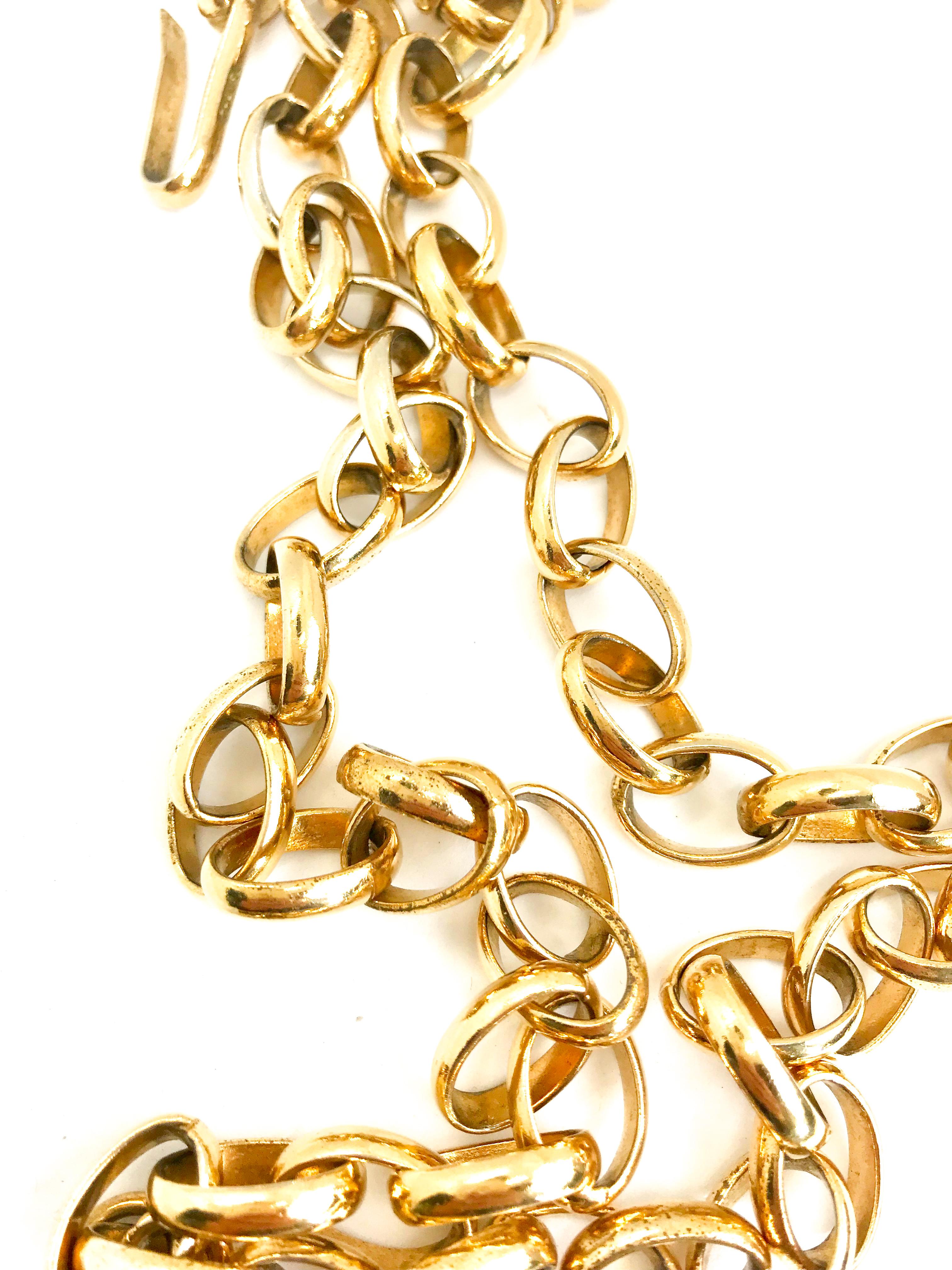 Huge Chanel 1980s vintage gold plated cutout pendant necklace / belt.  Chanel your inner 90s supermodel!

Features Chanel stamp on hook which was used briefly in the early 80s.  Long chunky chain which can be worn as a necklace or belt.

Chain