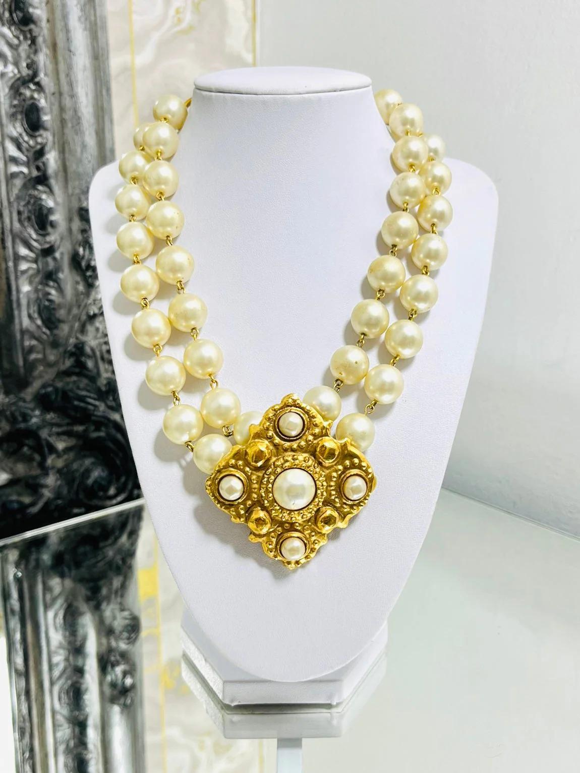 Chanel 1980's Vintage Pearl & 24k Gold Plated Necklace

Double stranded with large centre diamond shaped with hammered style and pearls. Gold chain closure with dangle 'CC' logo.

Additional information:
Size – One Size
Composition – Faux Pearl, 24k