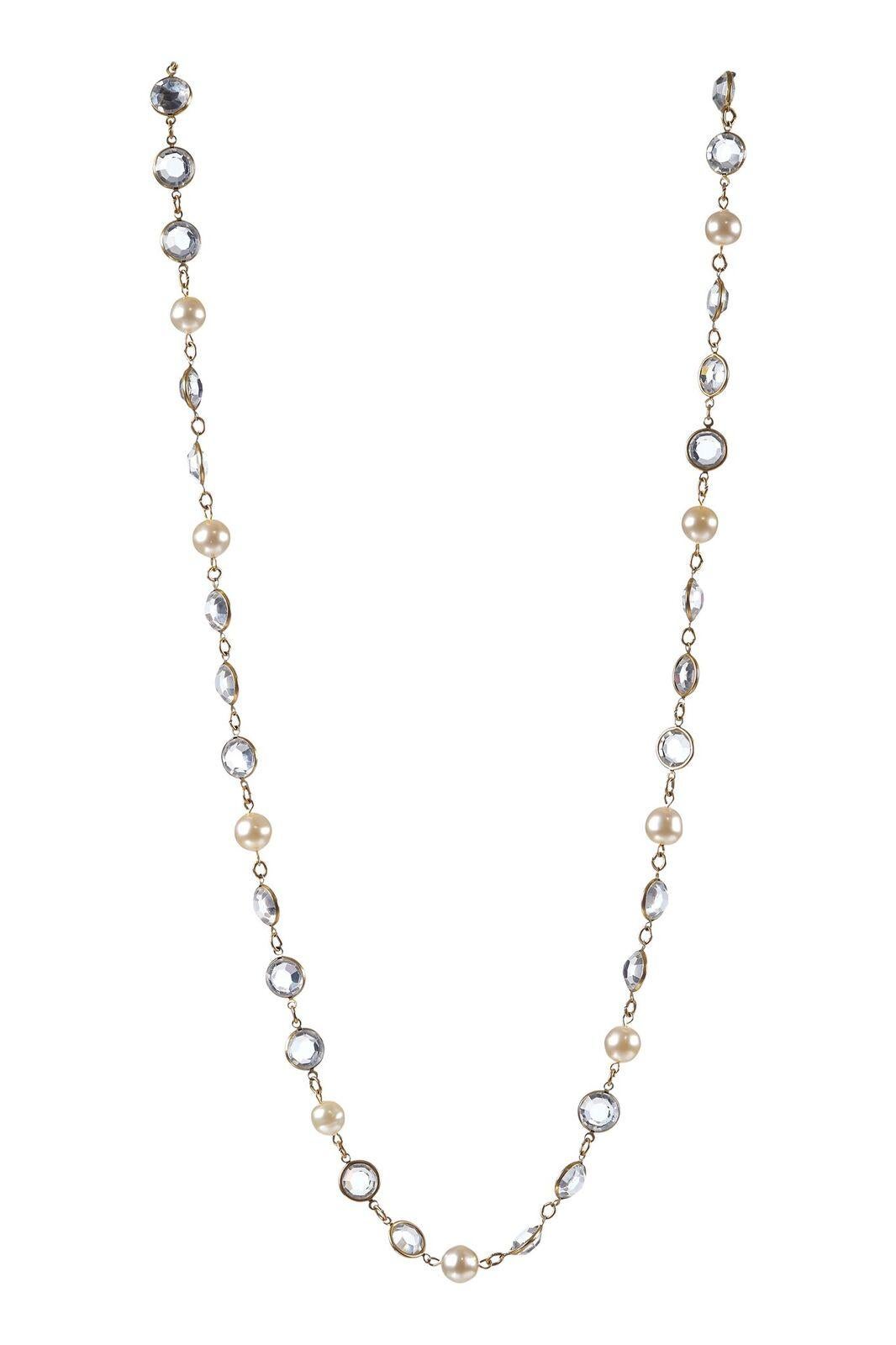 This beautiful Chanel gold tone sautoir necklace with cut crystal and pearlescent beads is delicate and feminine and in excellent condition. Each crystal is set in a circular gold gilt frame with small link divisions between each charm. Can be worn