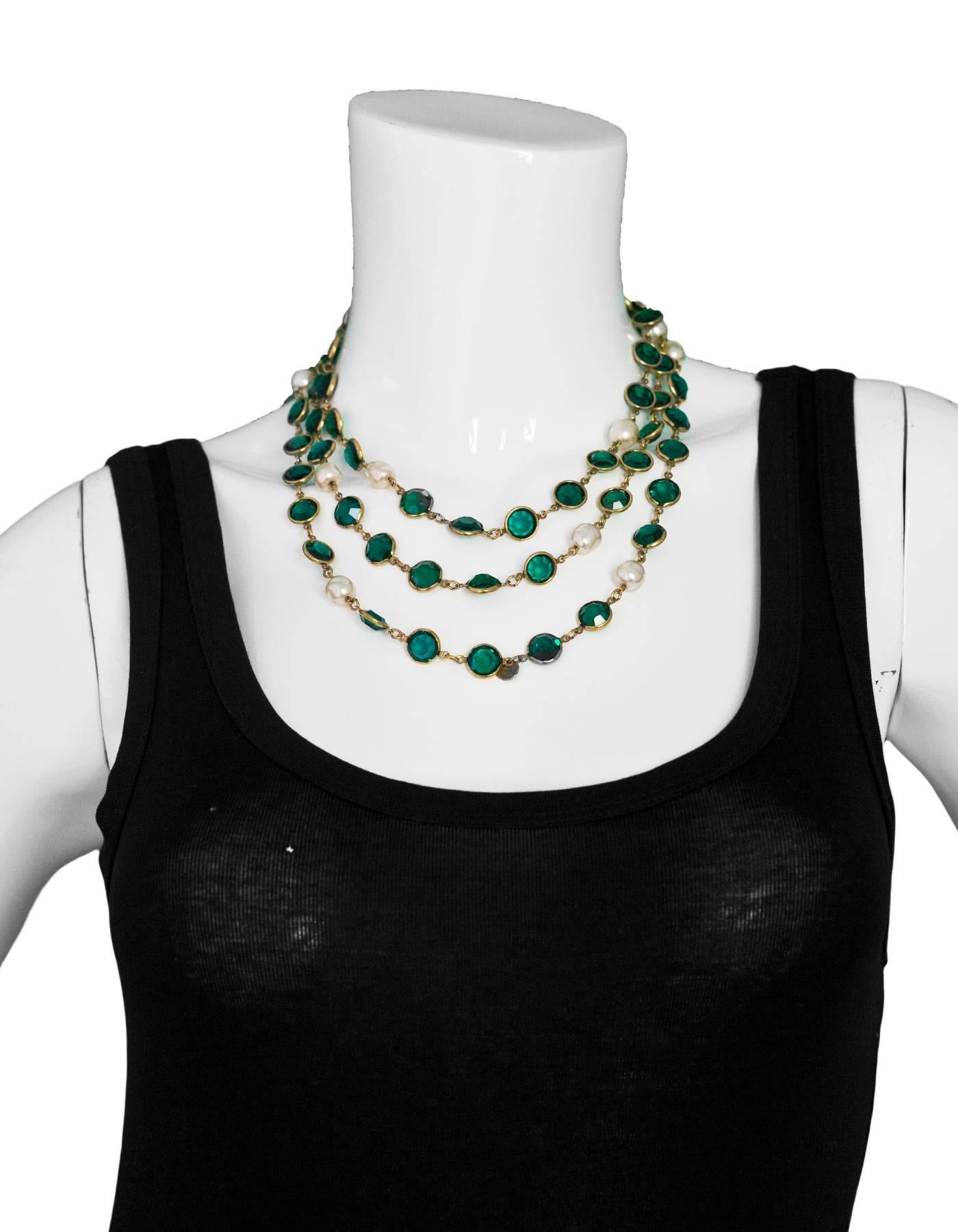 Chanel Green Crystal & Faux Pearl Sautoir Necklace

Year of Production: 1981
Color: Ivory, green, gold
Materials: Faux pearl,  crystal, metal
Closure: None
Stamp: Chanel 1981
Overall Condition: Excellent vintage pre-owned condition with the