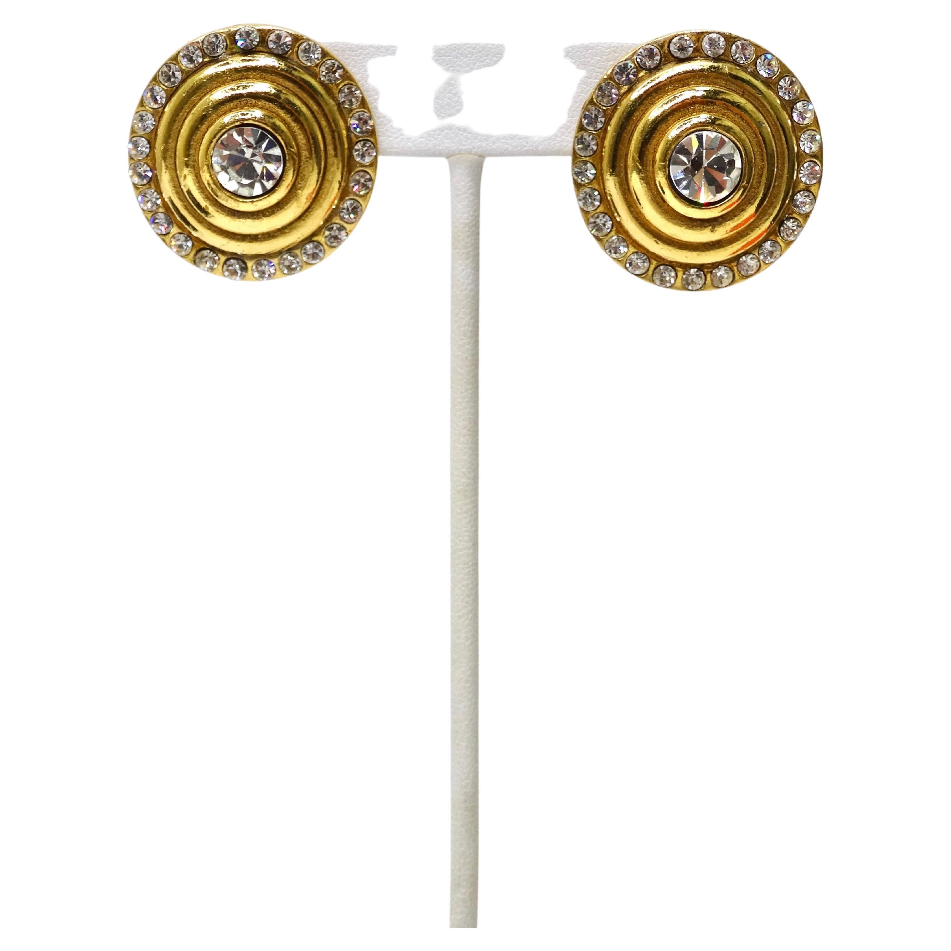 Chanel collectors right this way! These are beautiful Chanel clip on earrings featuring a large center crystal rhinestone in a vibrant gold tone metal. They are completely surrounded by small rhinestones accompanied by one large crystal in the