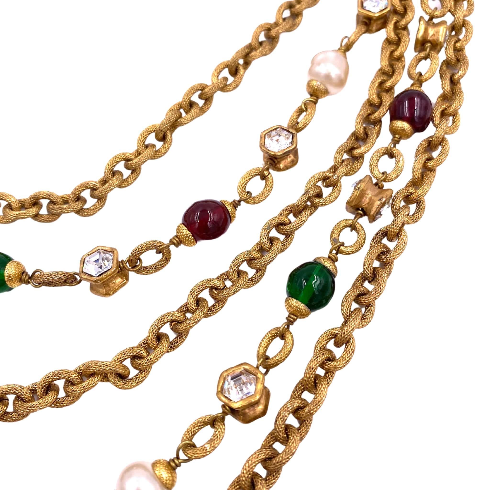 Experience timeless elegance with the Chanel 1984 Multi Chain Necklace. Featuring layers of green and purple stones, this necklace adds a touch of sophistication to any outfit. Elevate your style and make a statement with this iconic piece from