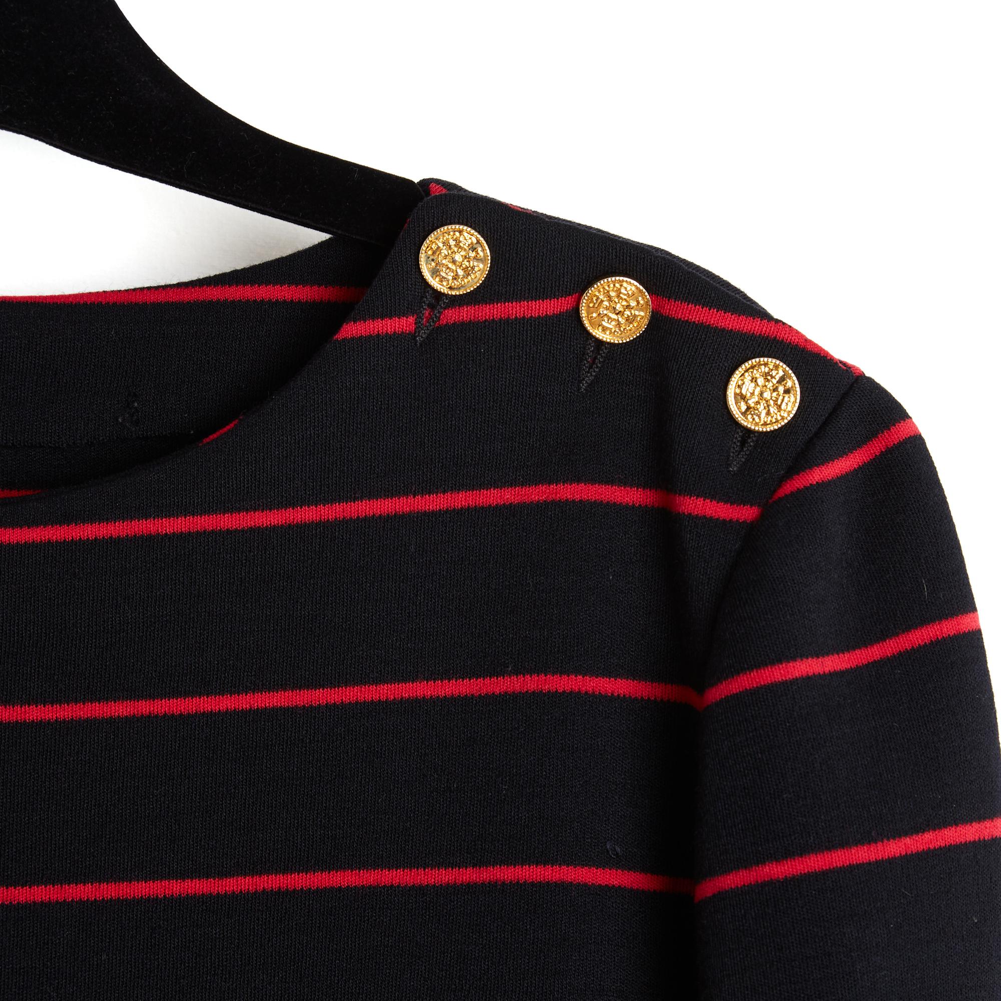 Chanel top, sailor sweater circa 1985 in thick black wool jersey with red stripes, round neck closed by 3 buttons on the shoulder, straight cut, long sleeves closed by 2 coordinated buttons, unlined. No more composition or size label but the