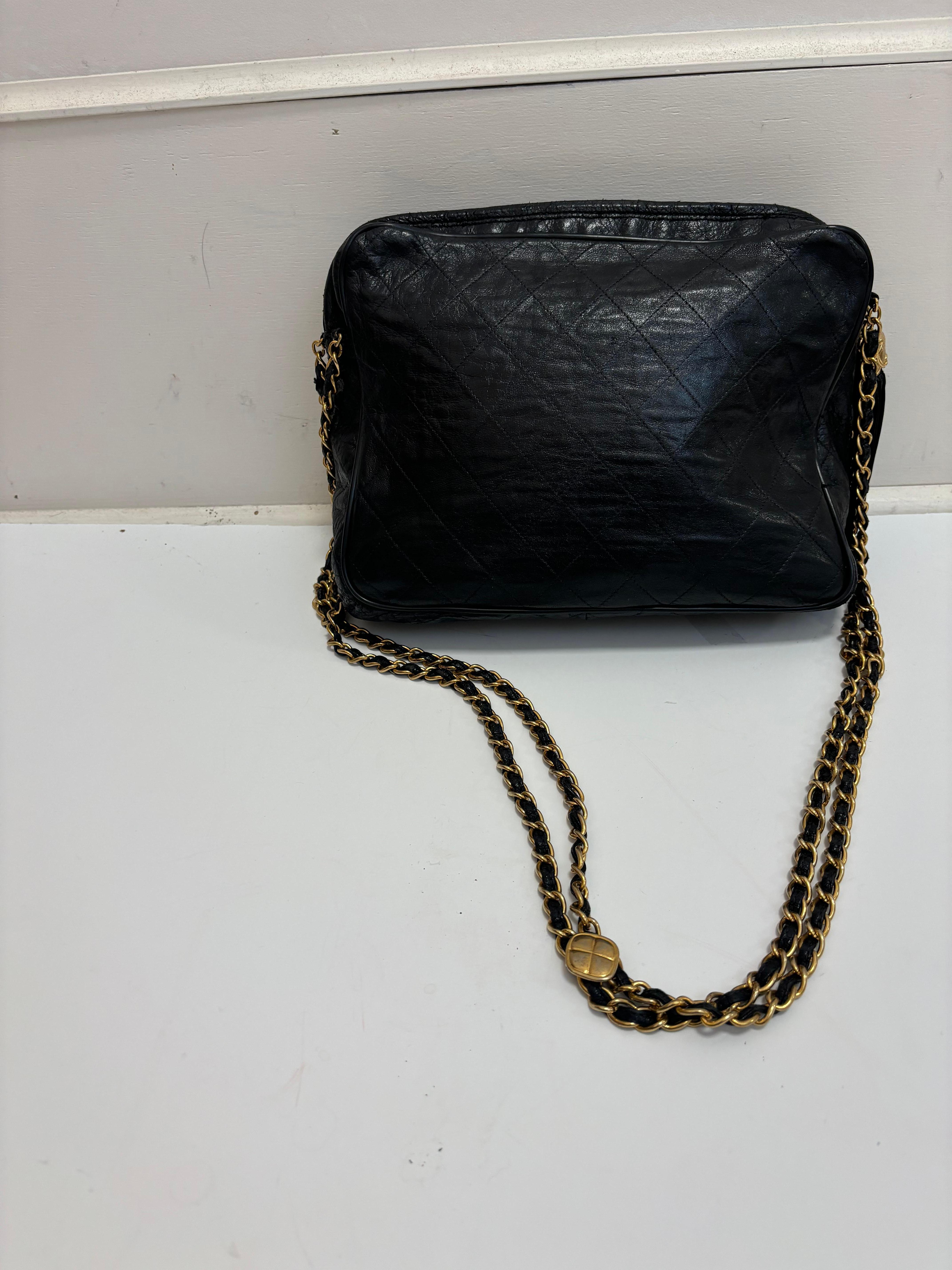 This is a rare 1989-91 Chanel vintage quilted lambskin CC camera bag with not only a tassels but also three escutcheon plates on the leather and gold-tone straps which binds them.
The leather is nice and soft with minor scrapes as shown. It can be