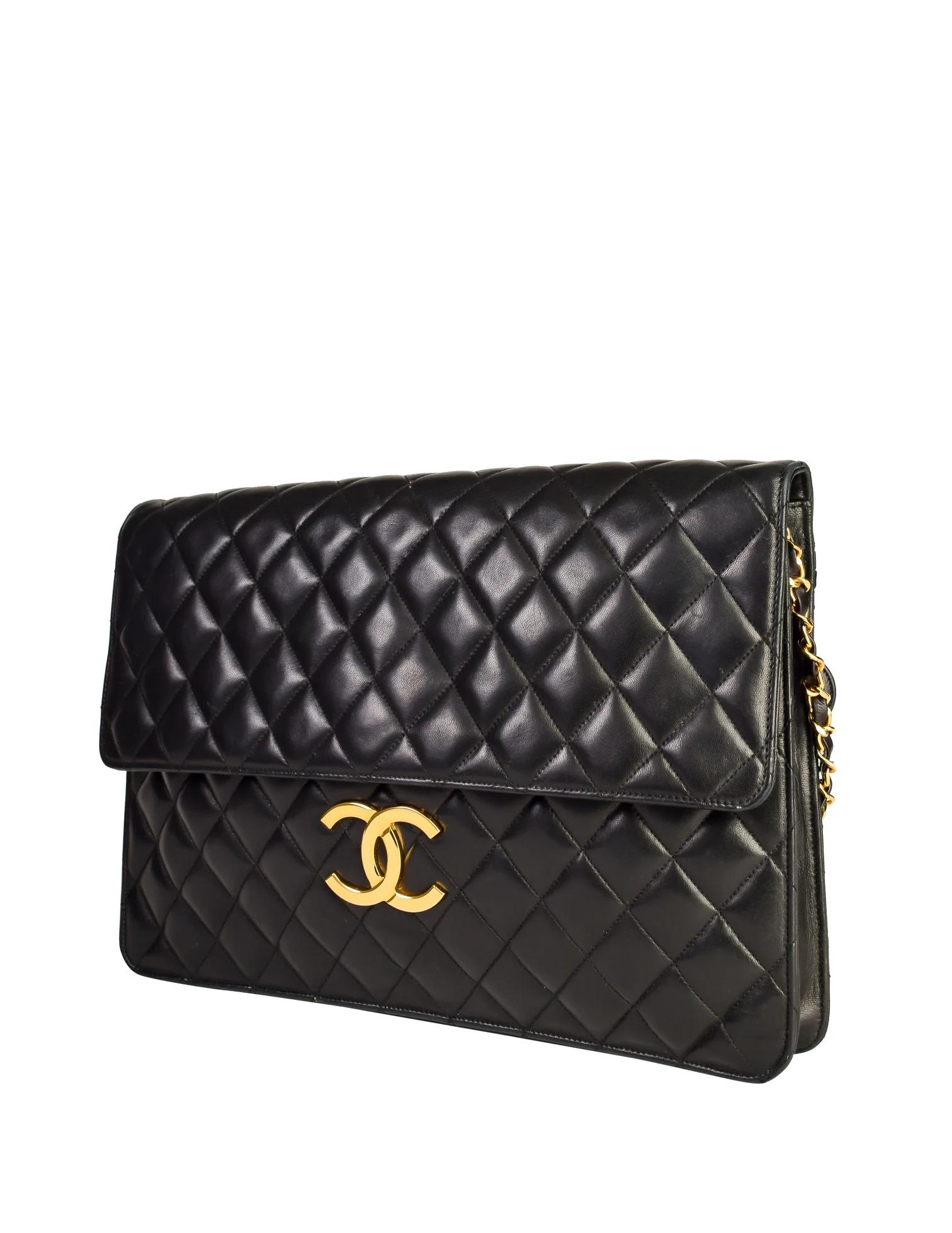 Chanel Rare Jumbo Maxi XL Vintage Classic Flap Giant Clutch Briefcase

Year: 1989-1991 {Vintage 35 Years}

Gold hardware
Black quilted lambskin leather
Snap closure under front flap
Large CC logo at front  
Classic interwoven chain
Rear zippered