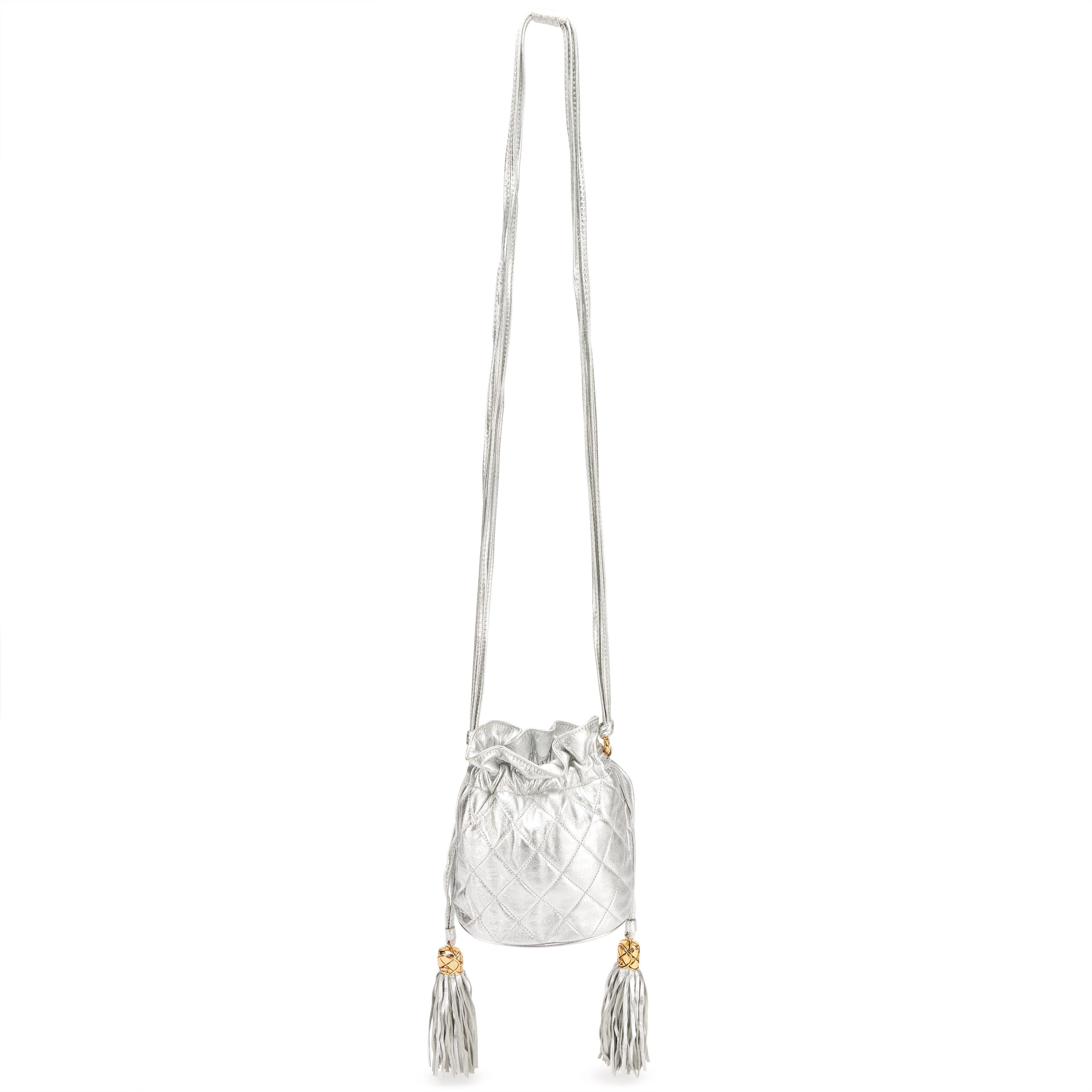 Chanel Vintage Metallic Silver Quilted Mini Lambskin Drawstring Tassel Bag

Year: 1990 {Vintage 34 Years}

Gold hardware
Quilted metallic silver lambskin leather


Light scratching to hardware. Moderate creasing throughout exterior. Light