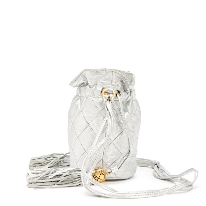 Chanel 1990 Vintage Metallic Silver Quilted Mini Lambskin Drawstring Tassel Bag In Excellent Condition For Sale In Miami, FL