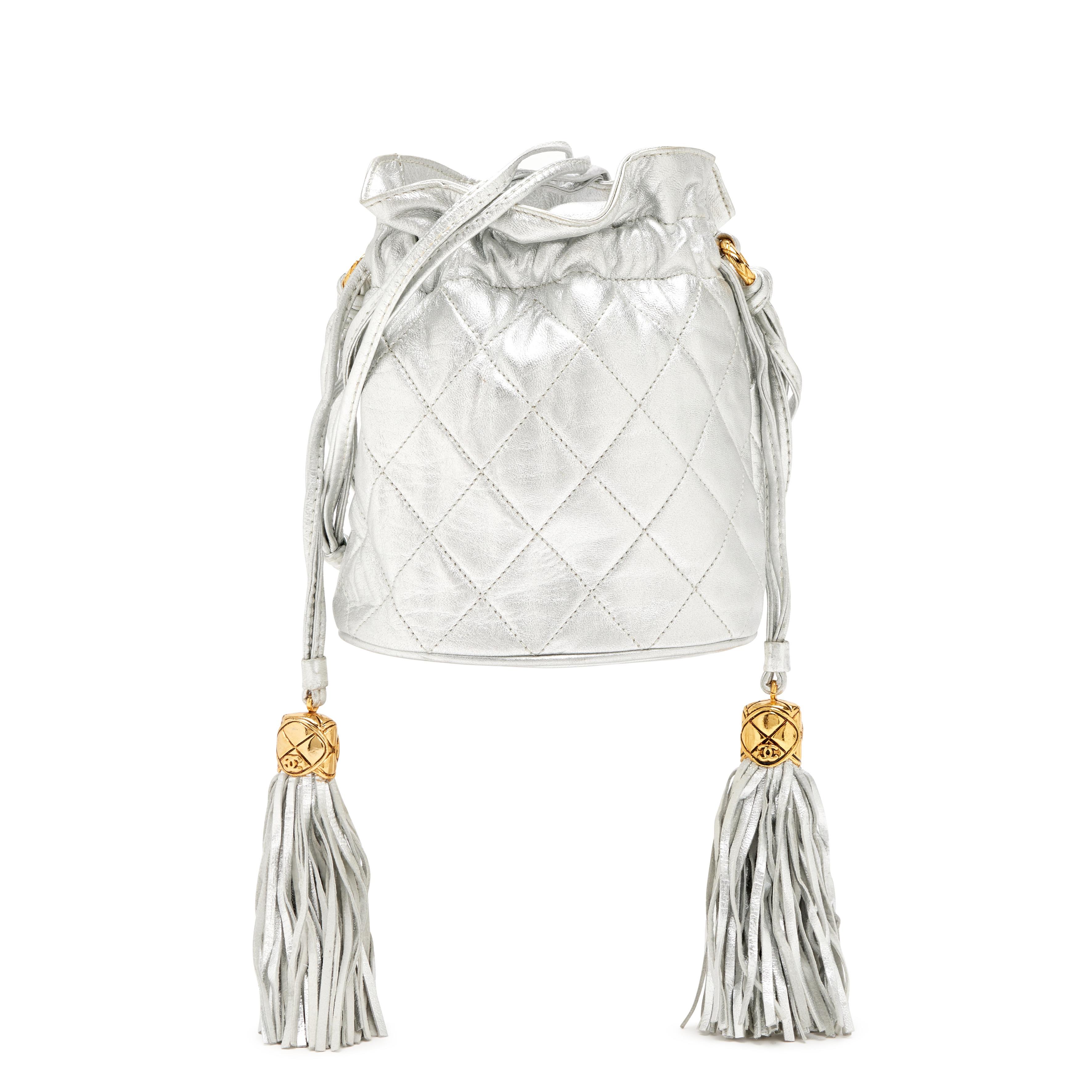 Women's Chanel 1990 Vintage Metallic Silver Quilted Mini Lambskin Drawstring Tassel Bag For Sale