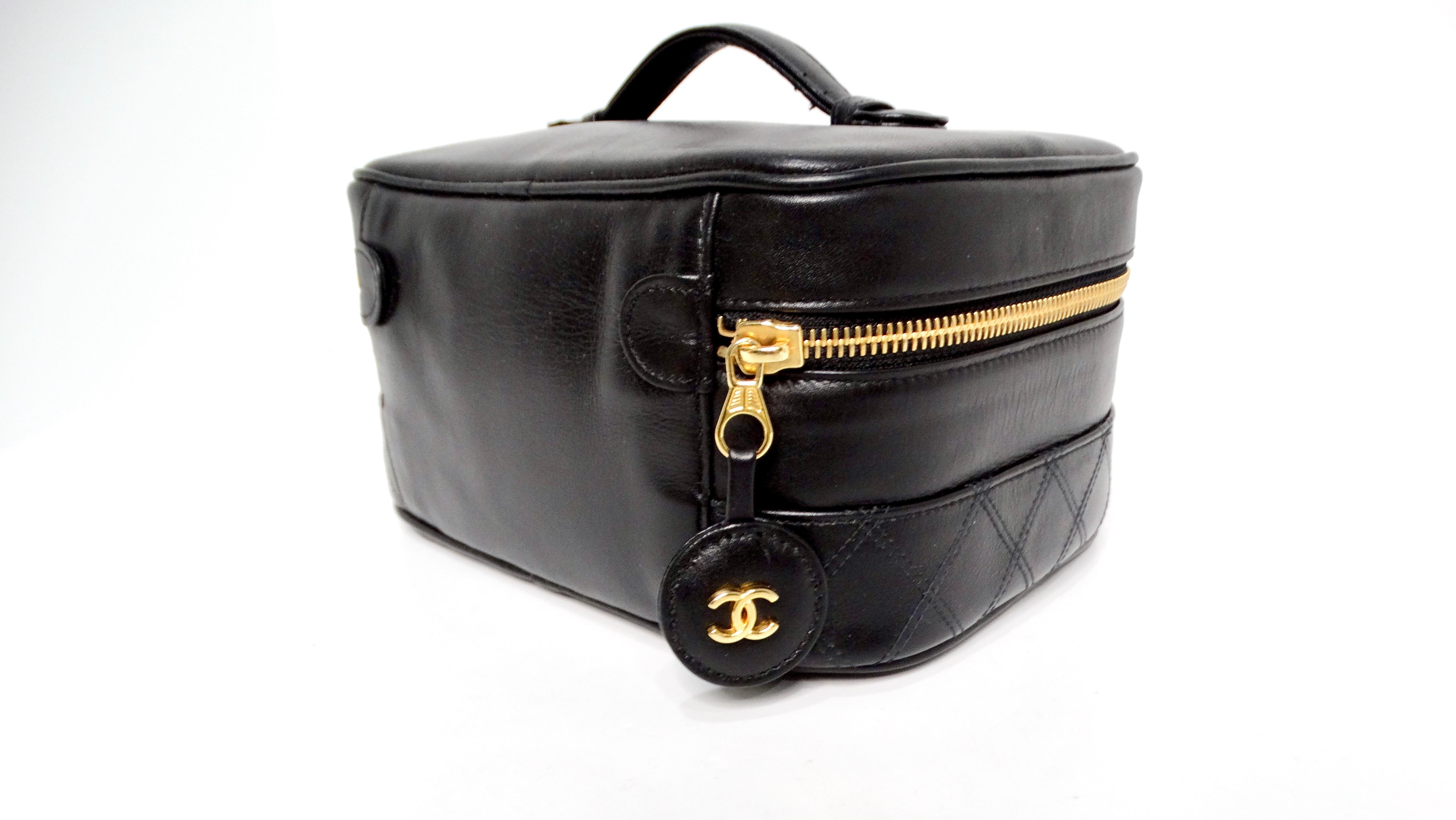 The Chanel 1990s Black Quilted Lambskin Vanity Case is an iconic accessory that embodies timeless elegance and practicality. Crafted from luxurious lambskin leather, this sleek rectangular box-shaped bag showcases a beautiful all-black exterior,