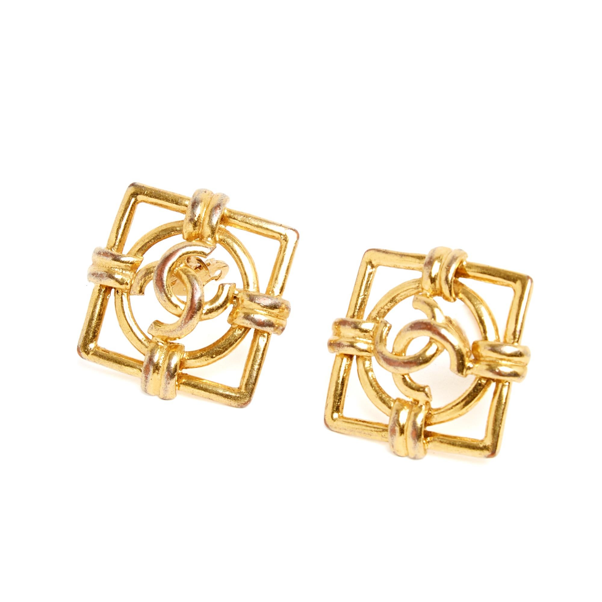 Chanel clip-on earrings circa 1990 by Victoire de Castellane in gold-plated metal with a CC logo motif in a circle itself within a square. Each side measures approximately 3.3 cm and the width or height, when worn, is 3.9 cm. The earrings no longer