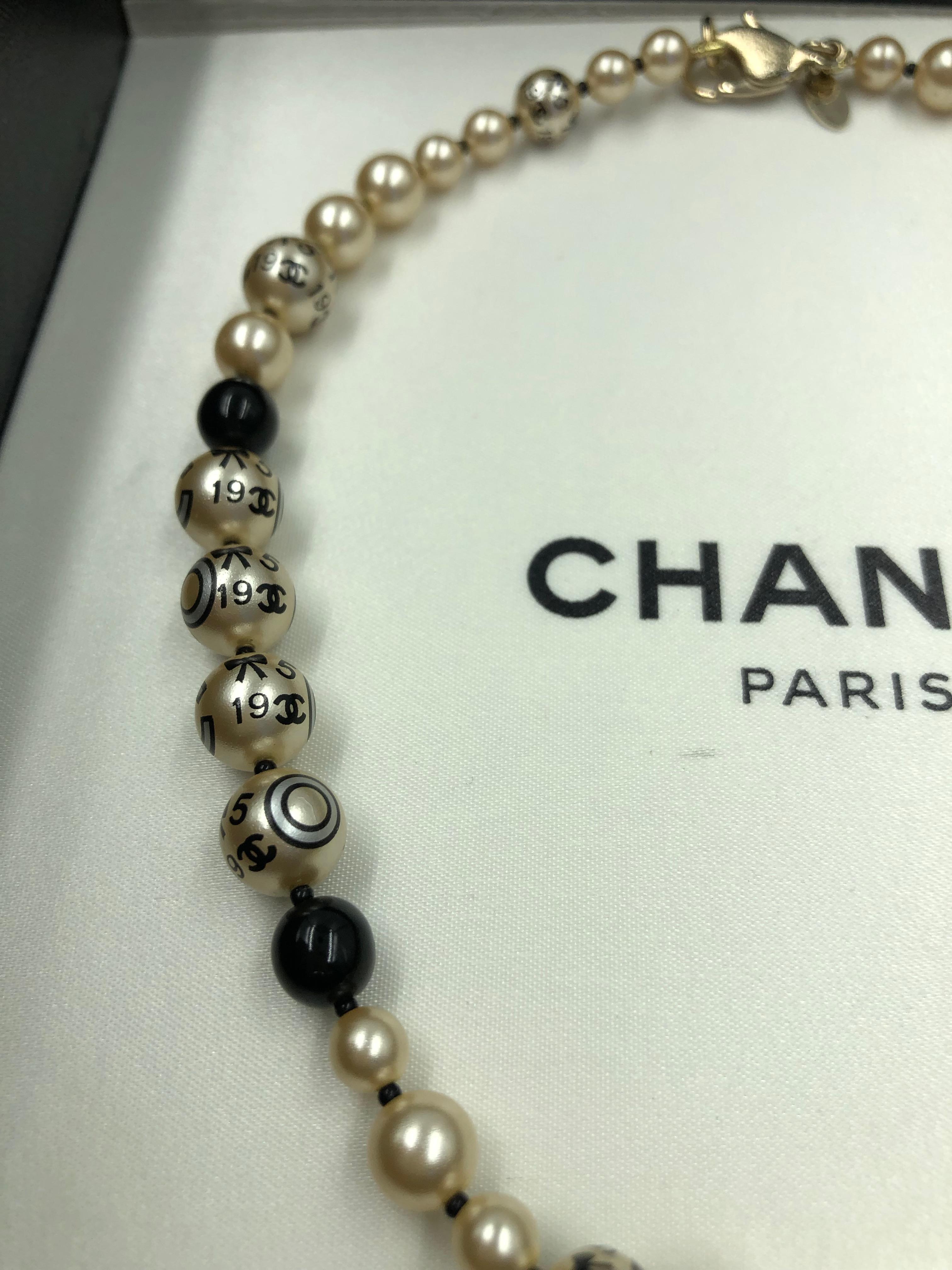 Women's or Men's Chanel 1990's Faux Pearls with Coco Chanel Print on Strand