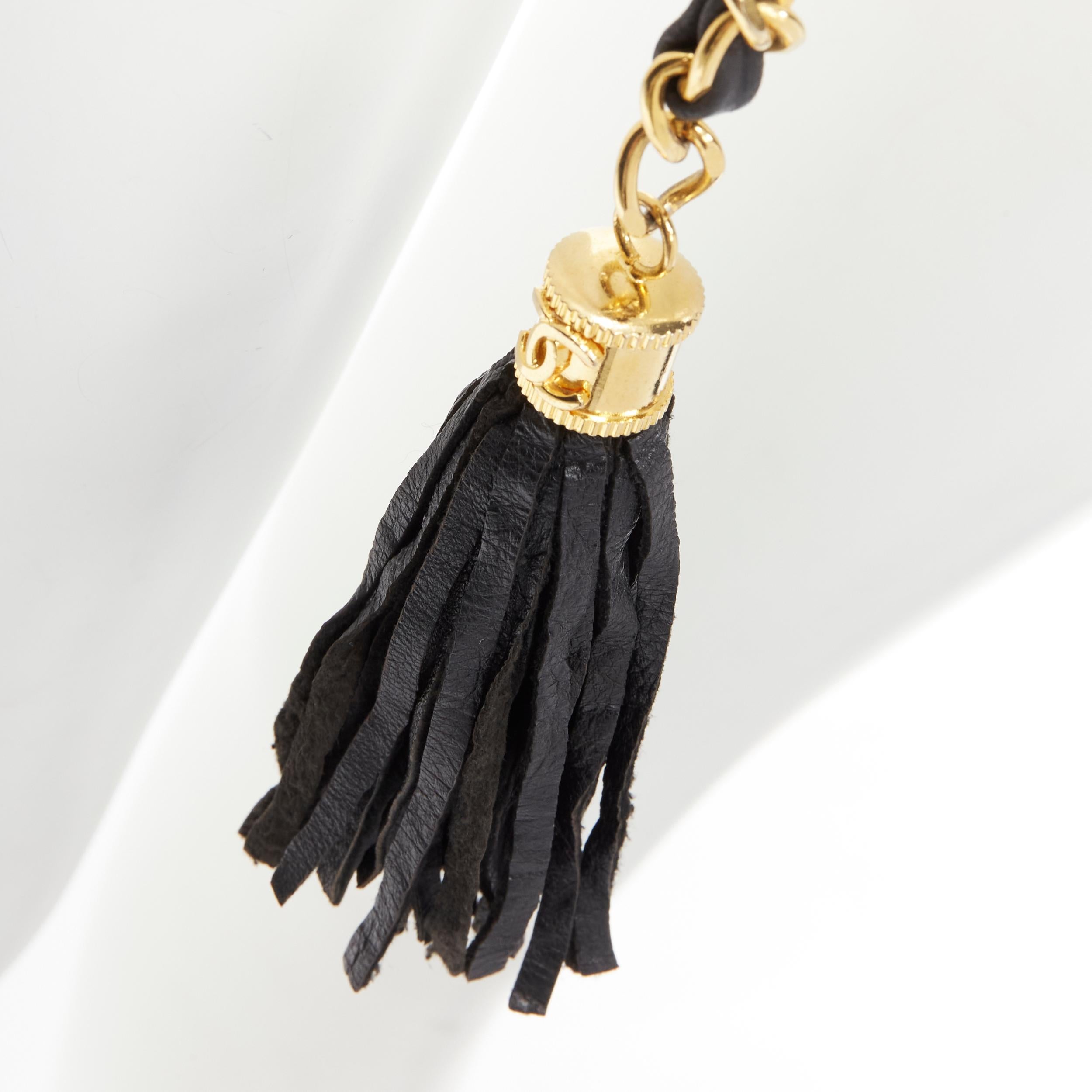 CHANEL 1990's Vintage gold chain leather interwoven link tassel charm belt
Brand: Chanel
Designer: Karl Lagerfeld
Collection: 1990's 
Material: Metal
Color: Gold
Pattern: Solid
Closure: Hook & Eye
Extra Detail: CC logo tassel