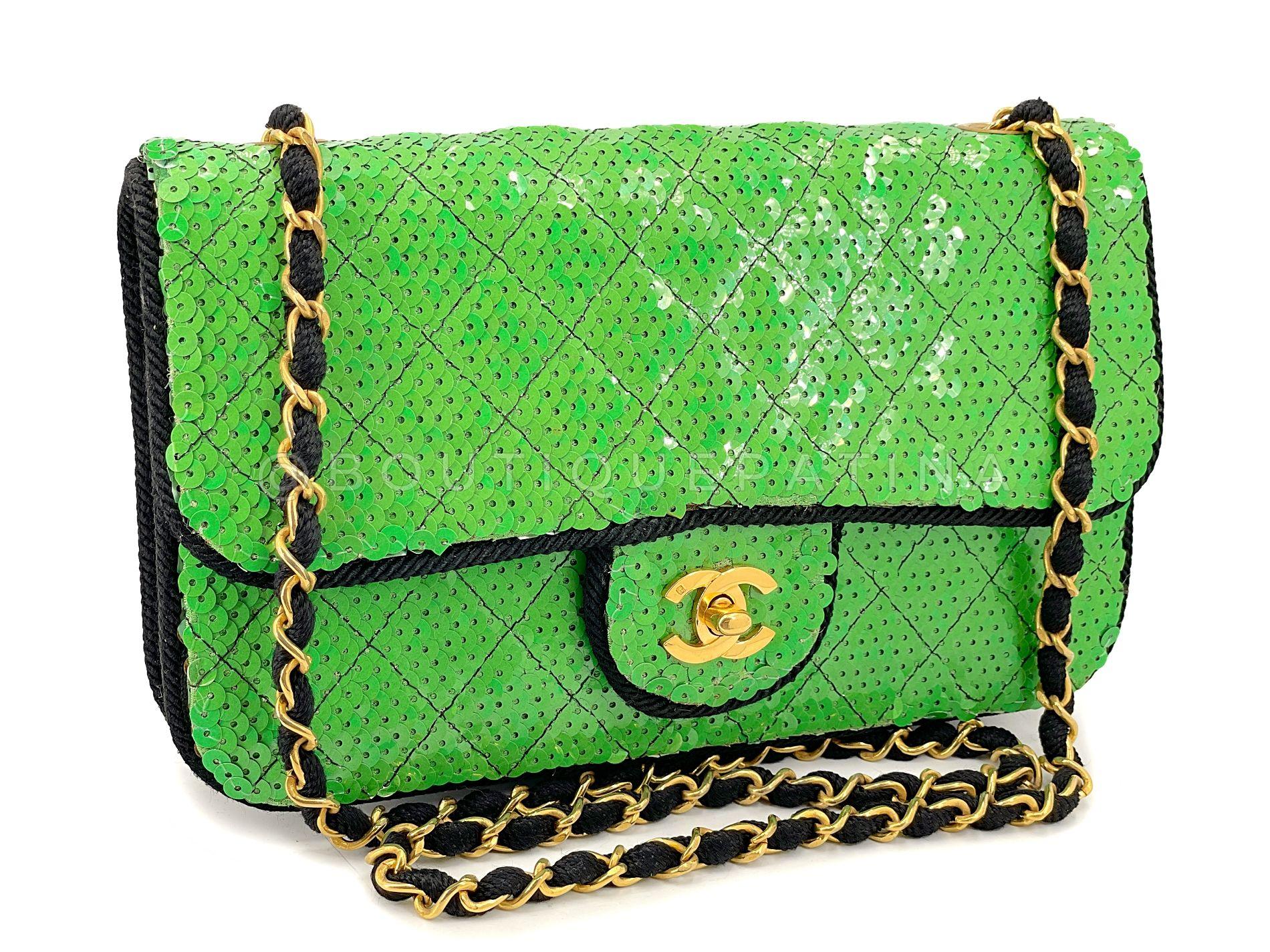Store item: 67976
This Chanel 1991 Vintage Iridescent Green Sequin Medium Flap Bag 24k GHW is a very rare collector's piece, with a grosgrain textured woven chain strap in 24k gold plated hardware, a roped silk trim  and a black canvas interior.