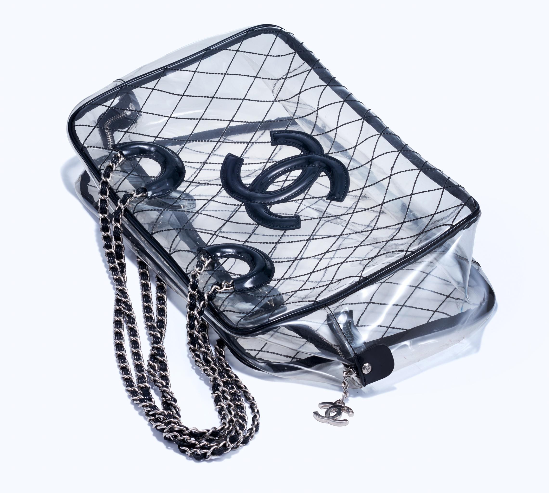 Year 1991  


As seen on Olivia Culpo! Unique vintage extra large Chanel transparent tote made of PVC and lined with patent leather. Features silver hardware, CC logo zipper detail, diamond stitching, patent leather thin interwoven classic chain,