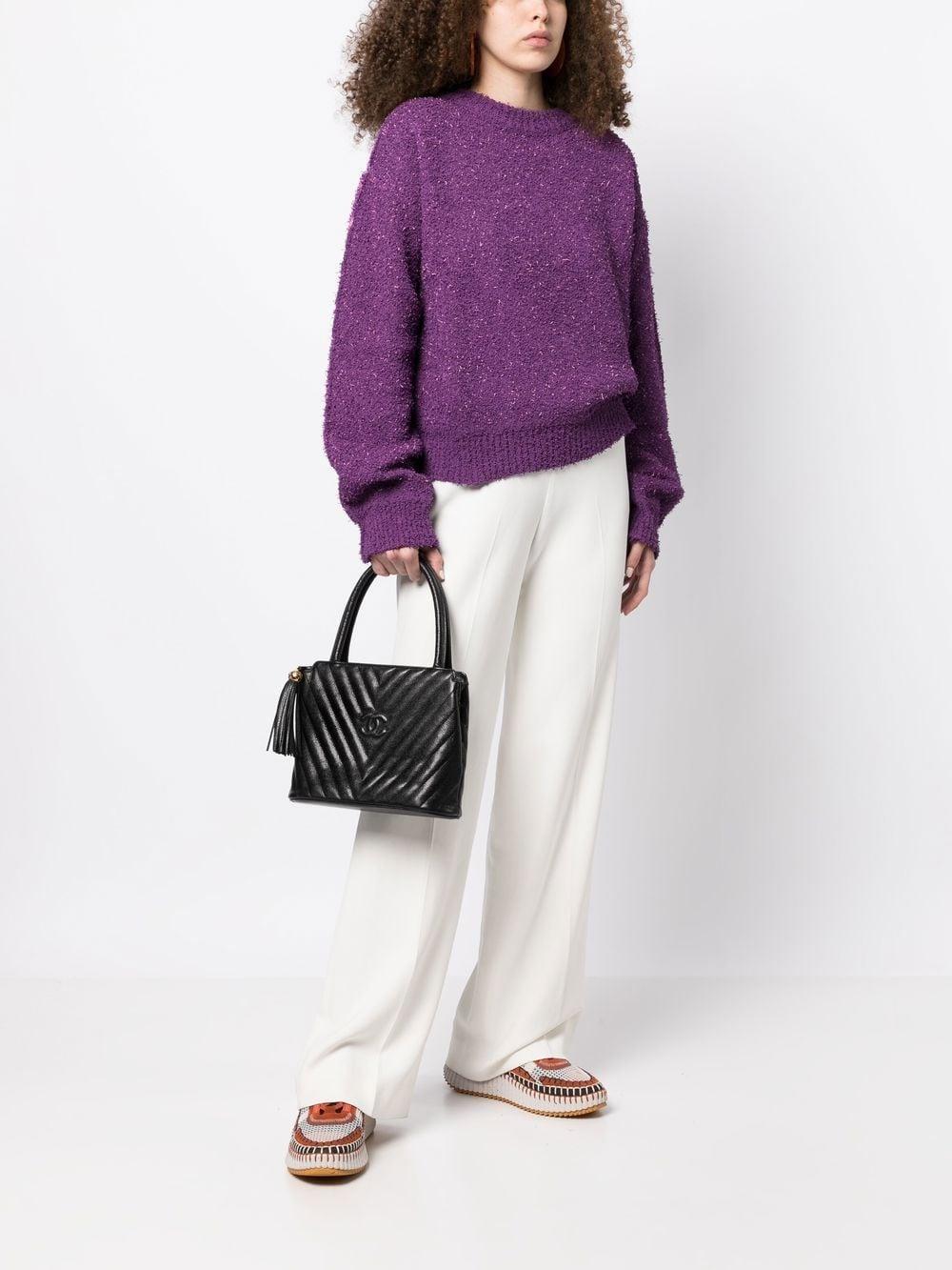 Chanel Vintage Black Caviar Chevron Tassel Fringe Tote Satchel Kelly Bag

1992 {Vintage 36 Years}

Gold hardware
Caviar chevron stitched pattern
Interlocking CC logo detail at center
Zip top closure with tassel fringe pull detail
Main interior