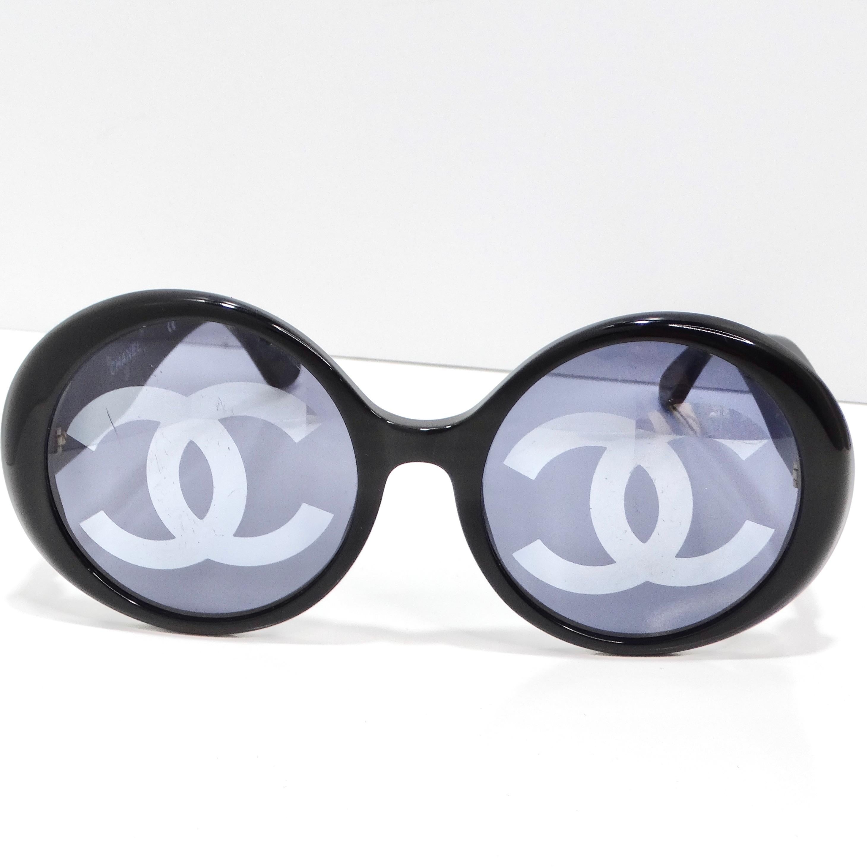 Indulge in a piece of fashion history with the Chanel 1993 Black CC Logo Round Lens Sunglasses, a rare and coveted find from Chanel's iconic 1993 runway show. These show-stopping sunglasses boast round lenses that exude timeless elegance, while the