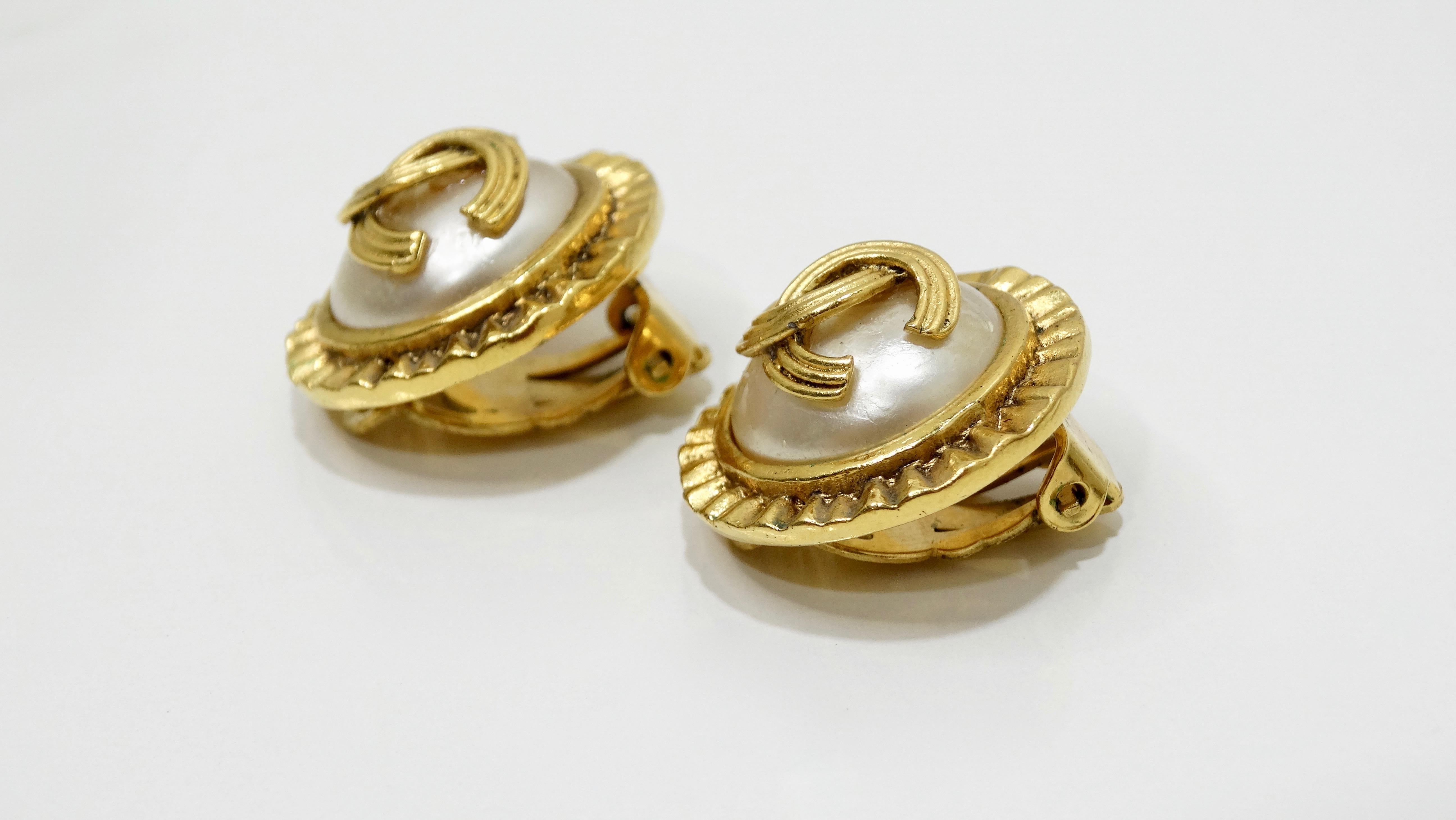 For every Chanel lover! Circa 1994 from Chanel's Autumn collection, these earrings feature a textured metal trim, an overall gold plated finish, a faux pearl center with the iconic CC on top and clip-on closures. Whether you're going out for the day