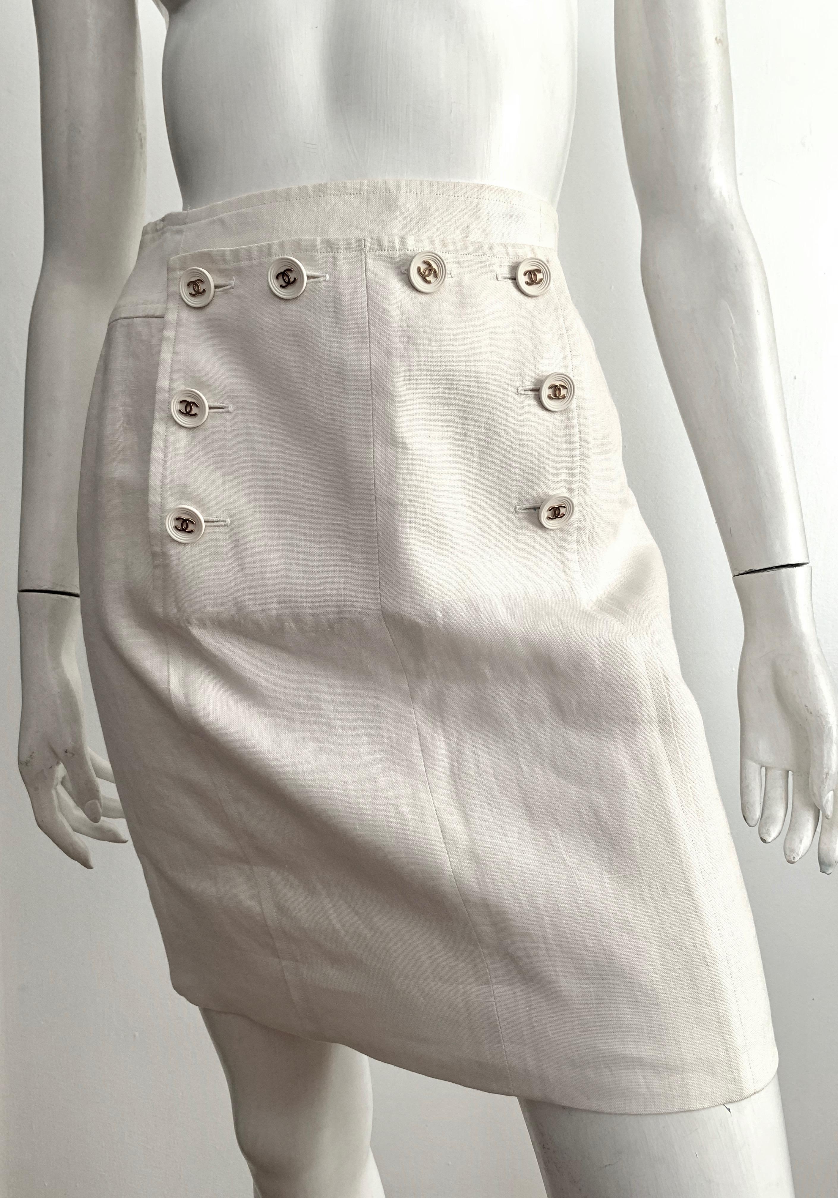 Chanel 1994 Spring Collection cream linen short skirt is a French size 38 and fits a size 4. 
Skirt is silk lined.
There are 8 logo Chanel buttons on front of skirt.
Skirt has a 27