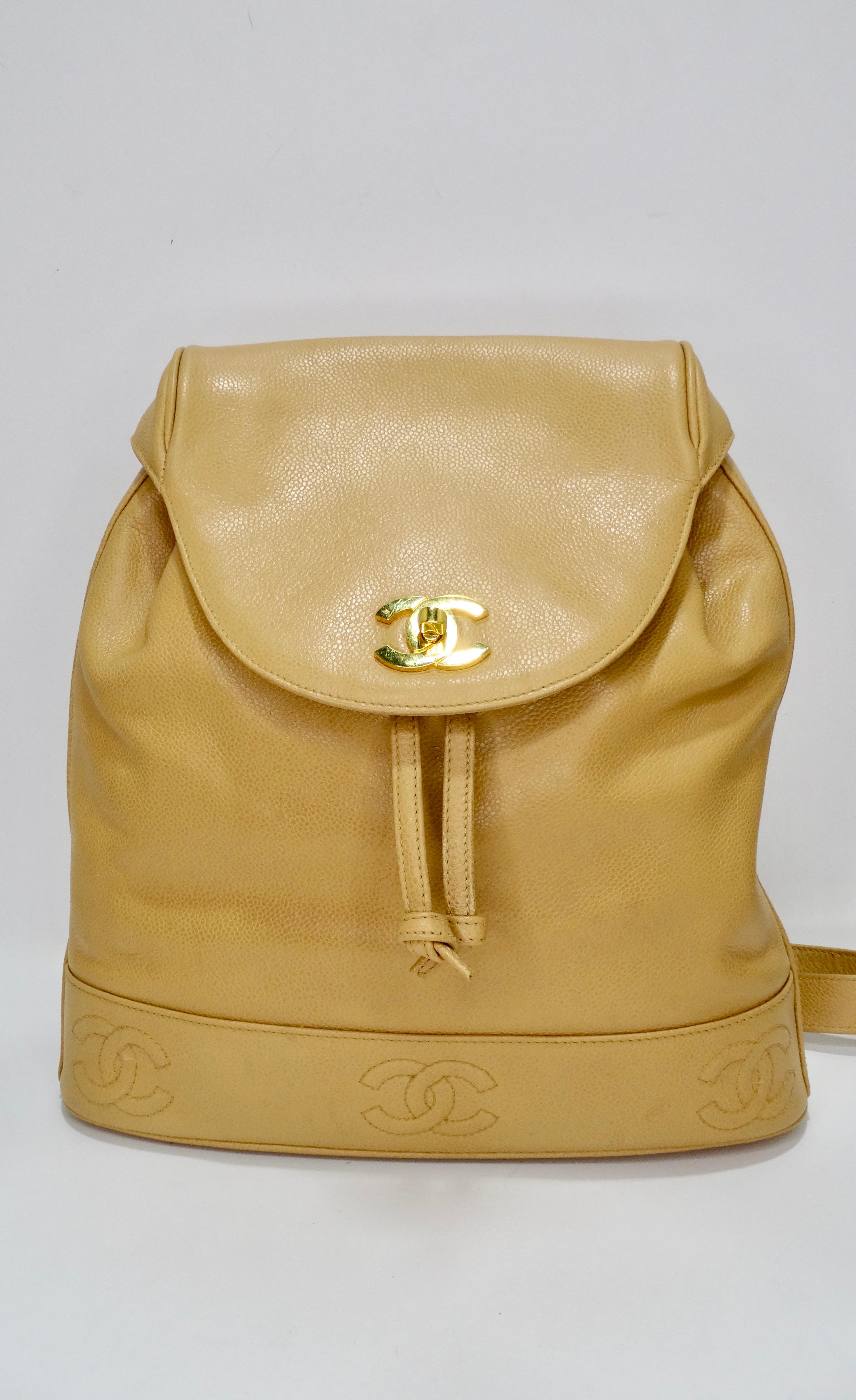 Keep it classic with this timeless Chanel backpack! Circa 1995, this backpack is crafted from tan caviar leather and features a drawstring fastening, gold plated hardware, a CC turnlock closure and CC's stitched around the base. Dual adjustable