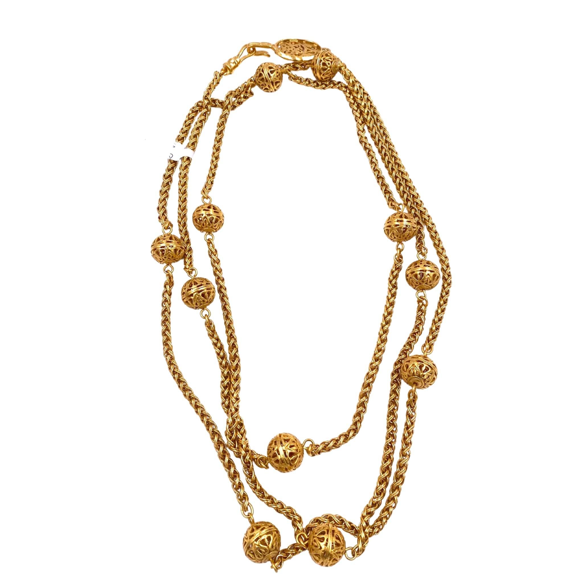 Elevate your style with this vintage Chanel 1995 Gold Long Chain. Featuring layers of intricate filigree balls, this piece adds a touch of elegance to any outfit. Own a piece of fashion history and stand out from the crowd with this luxurious
