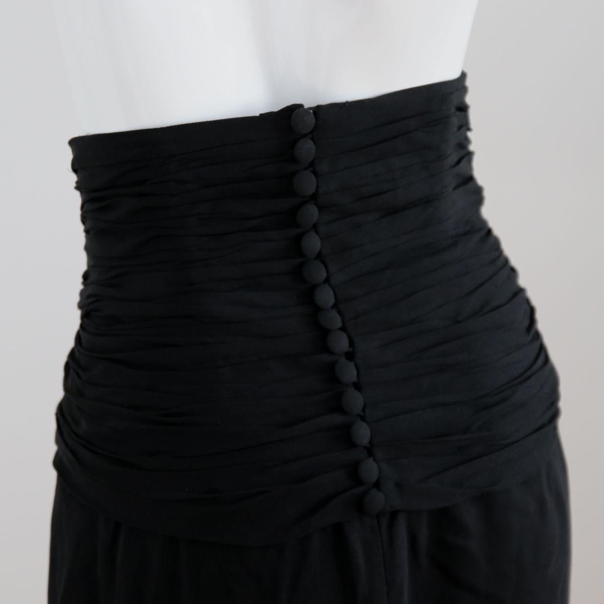 CHANEL 
 
1996. Luxury black skirt from Chanel by Karl Lagerfeld with high waist and button placket on the back. 
 
Buy Now Or Cry Later! 
 

The skirt is in good condition (see photos).
The wash label has been removed.
