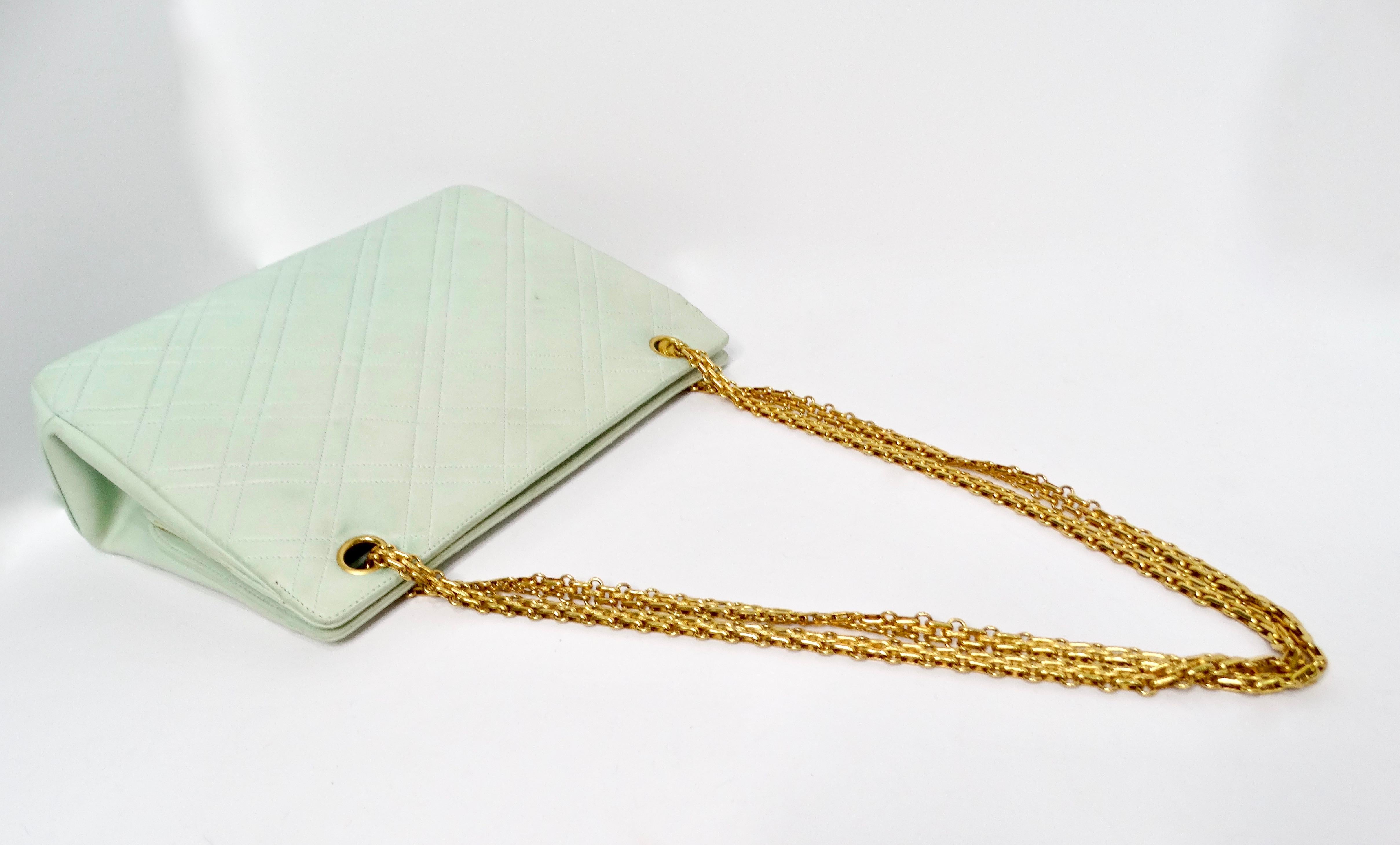 Introducing the exquisite Chanel 1996 Mint Green Lambskin Quilted Tote Shoulder Bag, a perfect blend of elegance and functionality. Crafted from luxurious lambskin leather, this vintage tote features the iconic quilted design of Chanel, giving it a