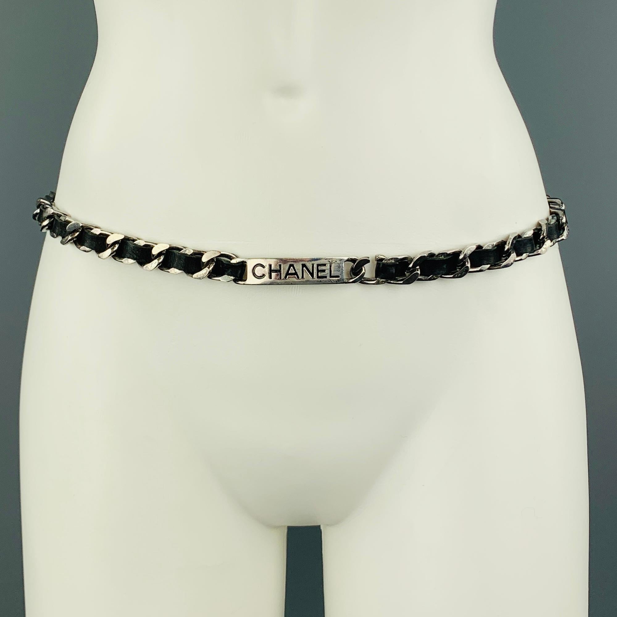 Vintage CHANEL circa Spring Summer 1996 belt comes in antique silver tone metal and features a thick curb chain strap with black woven leather and label embossed plaque.  Made in France.
 
Good Pre-Owned Condition.
Marked: 96 P
 
Length: 32