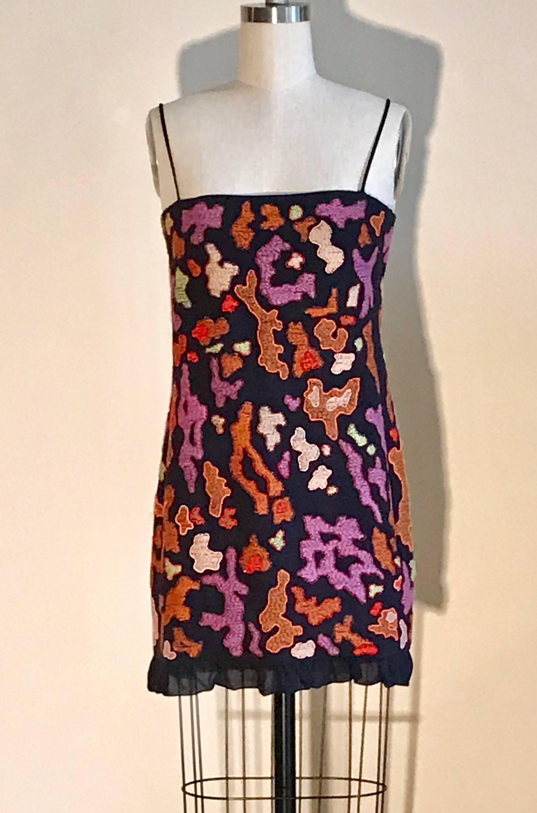 Chanel 1997 little black dress with a wild print from the Chanel Boutique collection. Mini length with spaghetti straps. Orange, purple, and green stitched patterns throughout with beaded borders. Chiffon ruffle at bottom. Back zip and hook and eye.