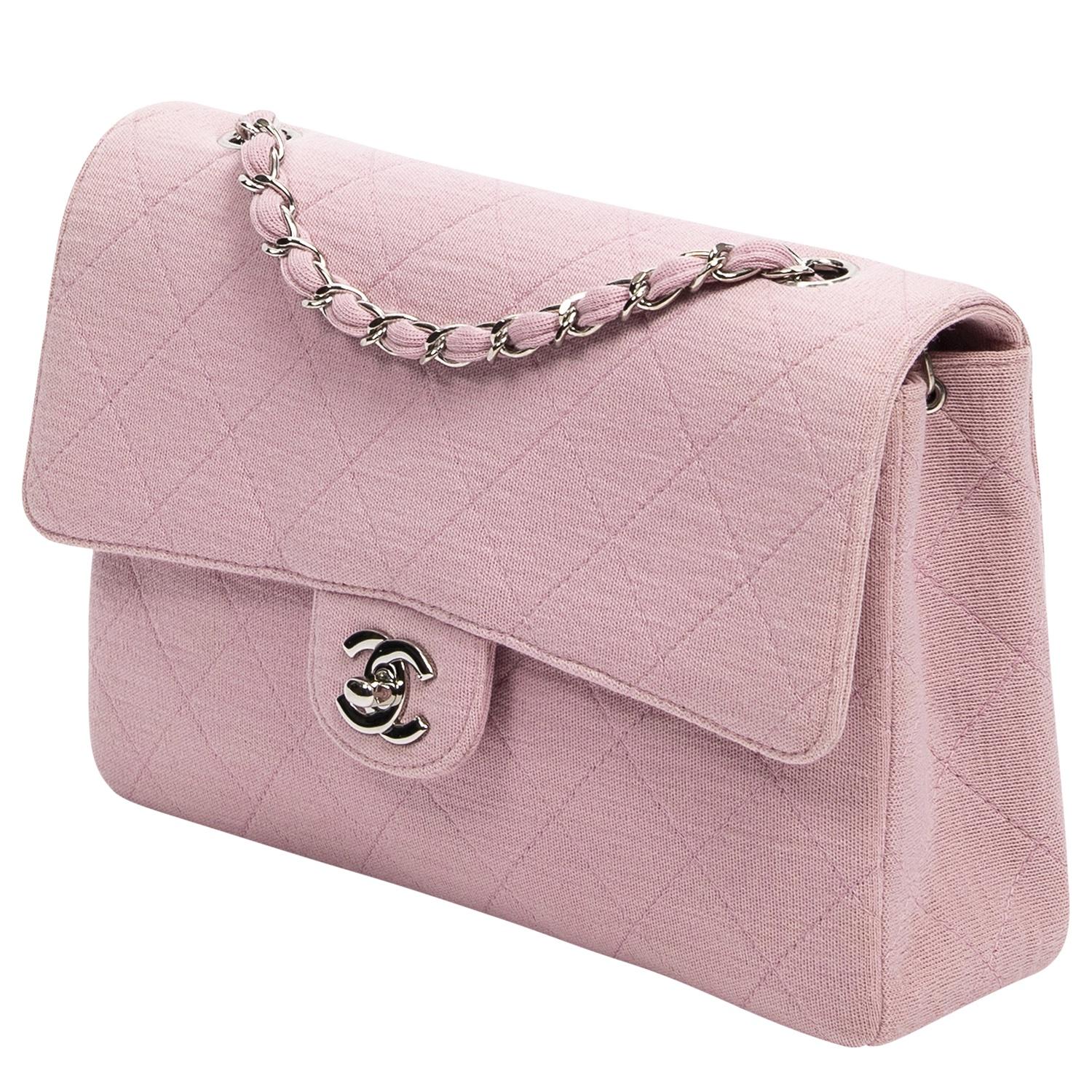 Late 90's pretty in pink vintage beauty. This one's for the subtle with a pop of color gals. Detailed in rose pink quilted canvas, silver-tone hardware, and a single exterior pocket to the back. The iconic CC turnlock closure opens to a leather
