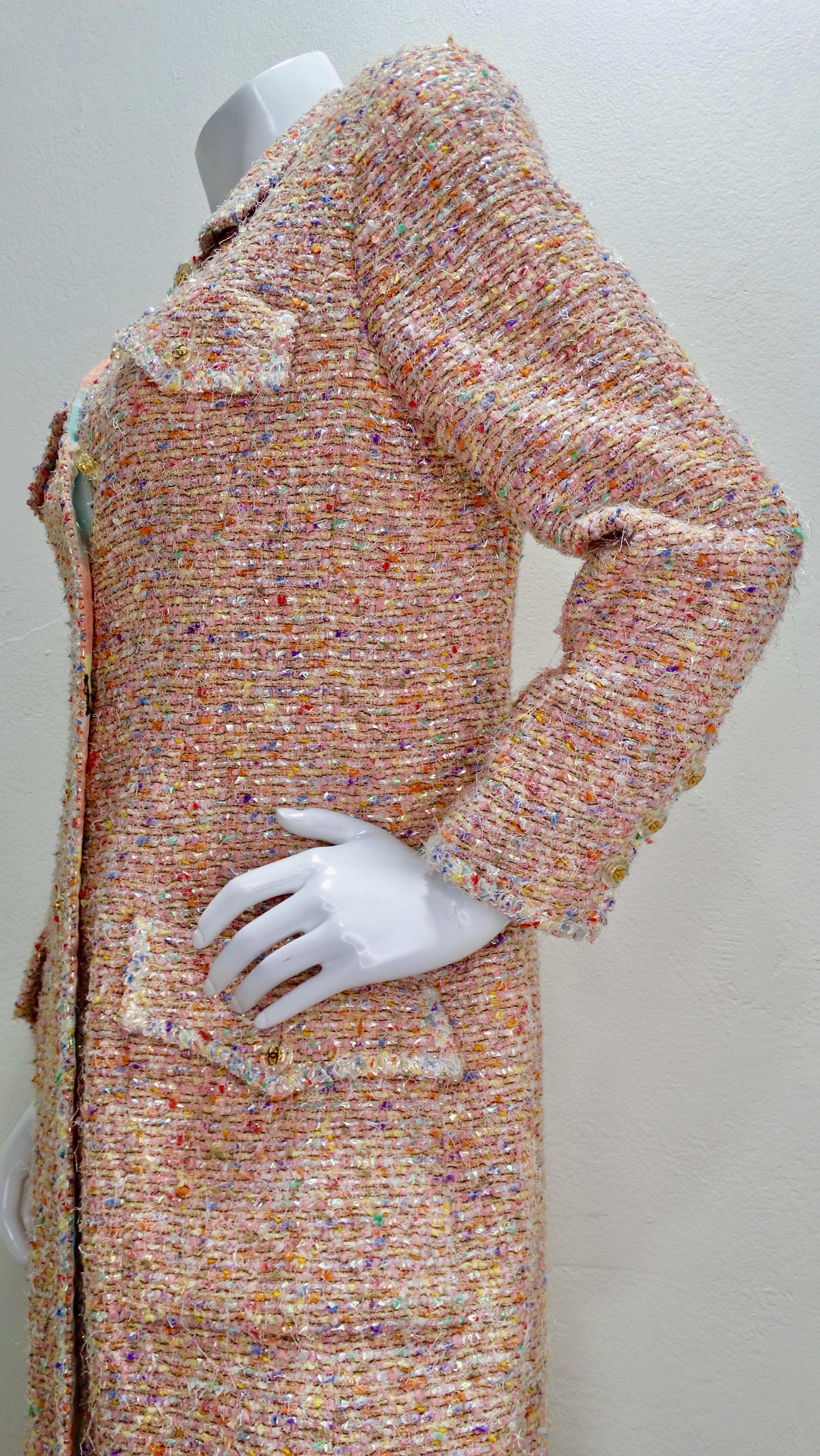 Calling all the ultimate Chanel lovers! Circa 1997 from their Spring collection, this coat is crafted from pastel colored tweed with colors like orange, pink, purple and yellow. Features clear acrylic buttons adorned with a mini gold CC and four