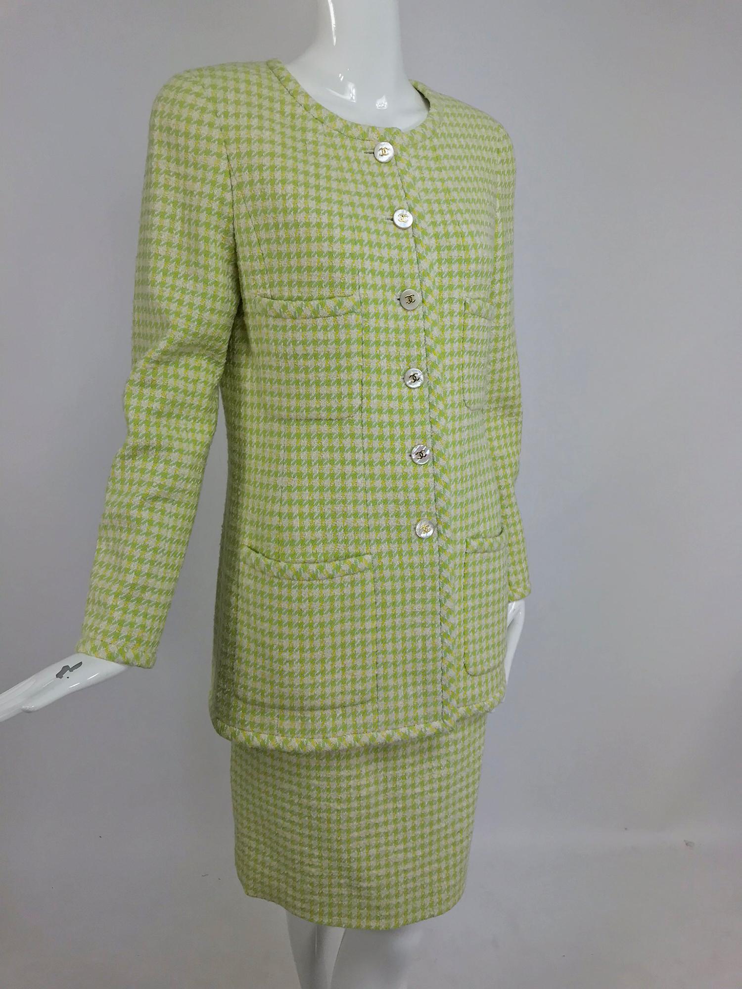 Chanel 1997P long silhouette four pocket jacket and skirt 42. This beautiful suit is done in mini check fabric in shades of mint green, yellow and cream. The hip length jacket has a jewel neckline, four patch pockets two up and two at the hip. The